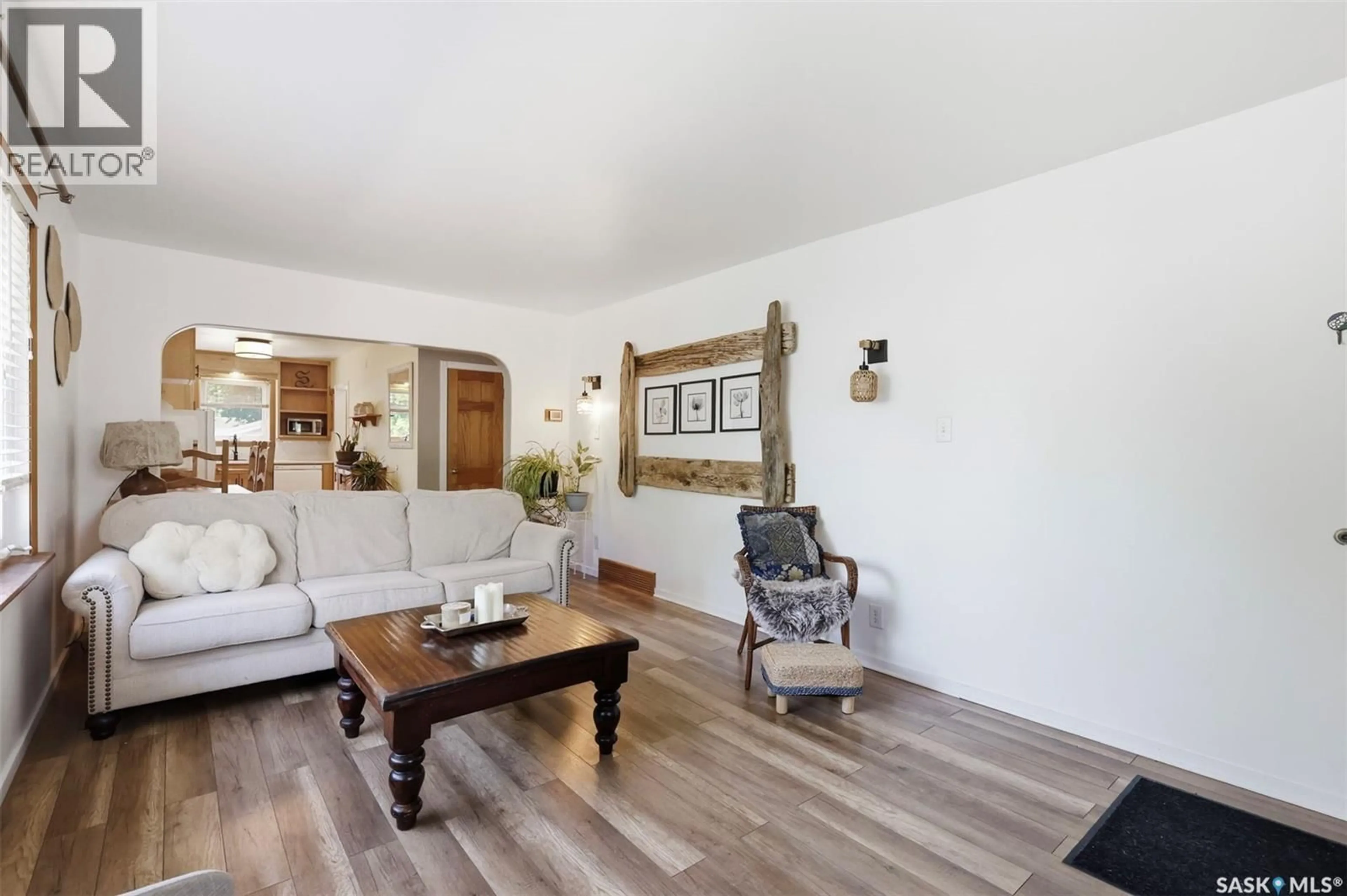 Living room with furniture, wood/laminate floor for 301 29TH STREET, Saskatoon Saskatchewan S7L0M2