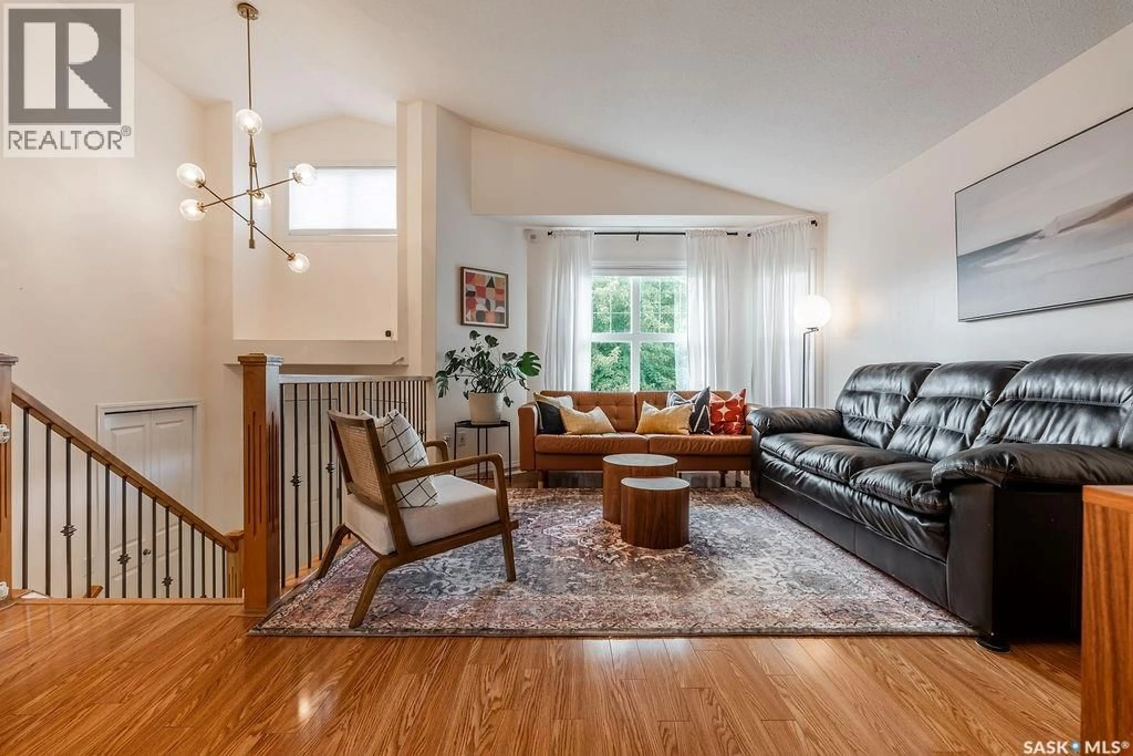 Living room with furniture, wood/laminate floor for 115 BLACKSTOCK COVE, Saskatoon Saskatchewan S7T0H4