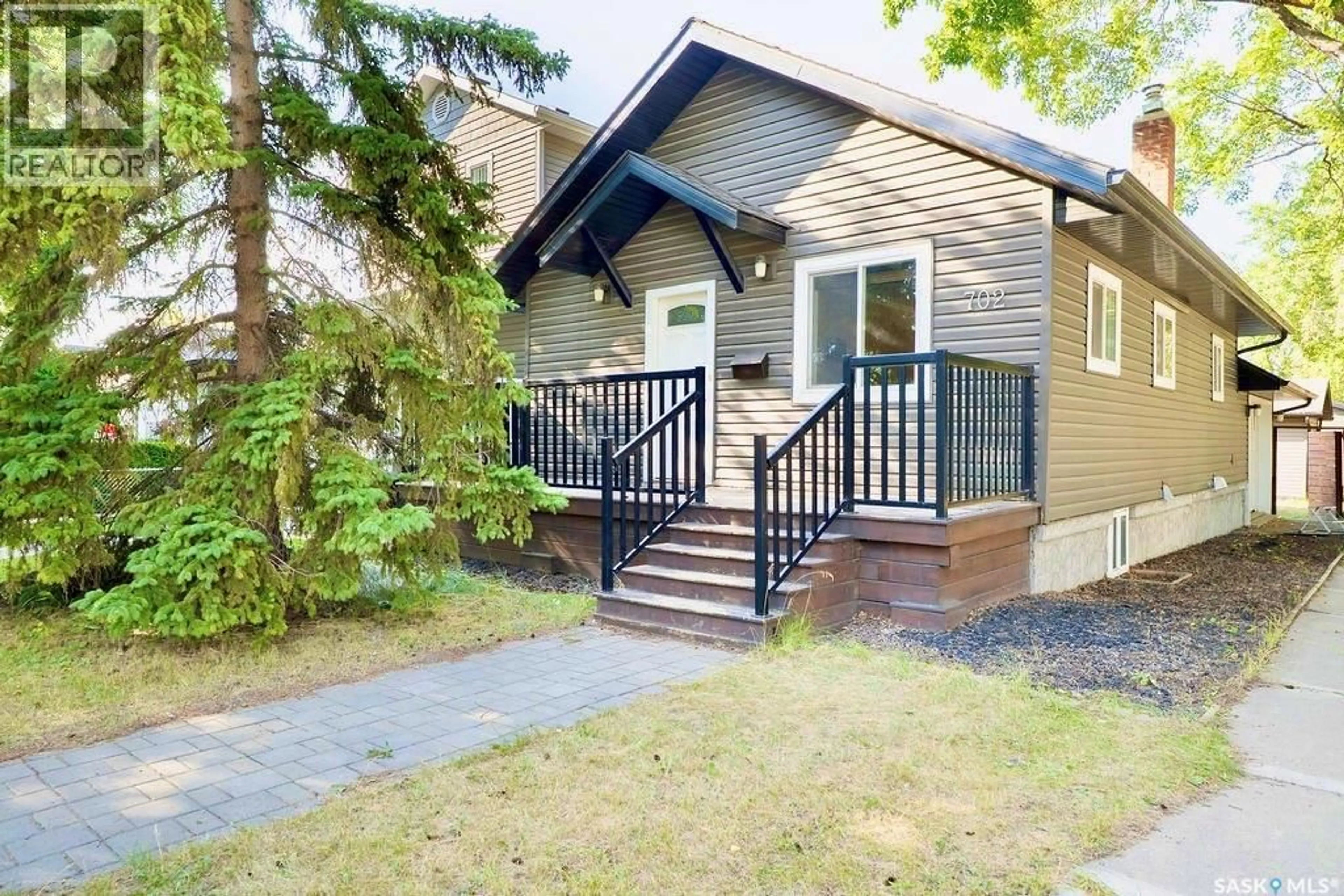Home with vinyl exterior material, street for 702 29TH STREET, Saskatoon Saskatchewan S7L0N1