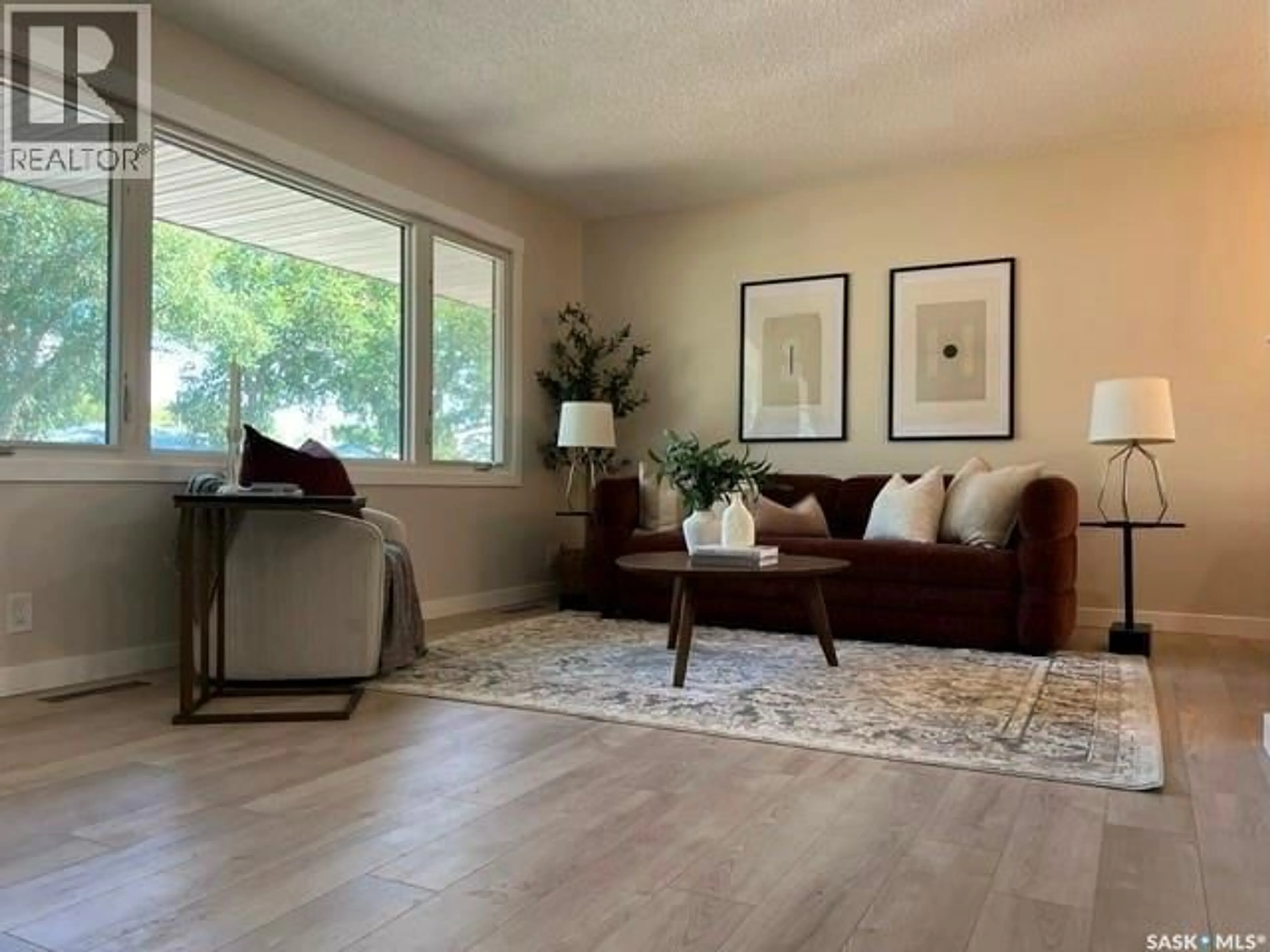 Living room with furniture, wood/laminate floor for 310 GARNET STREET, Regina Saskatchewan S4R3J1