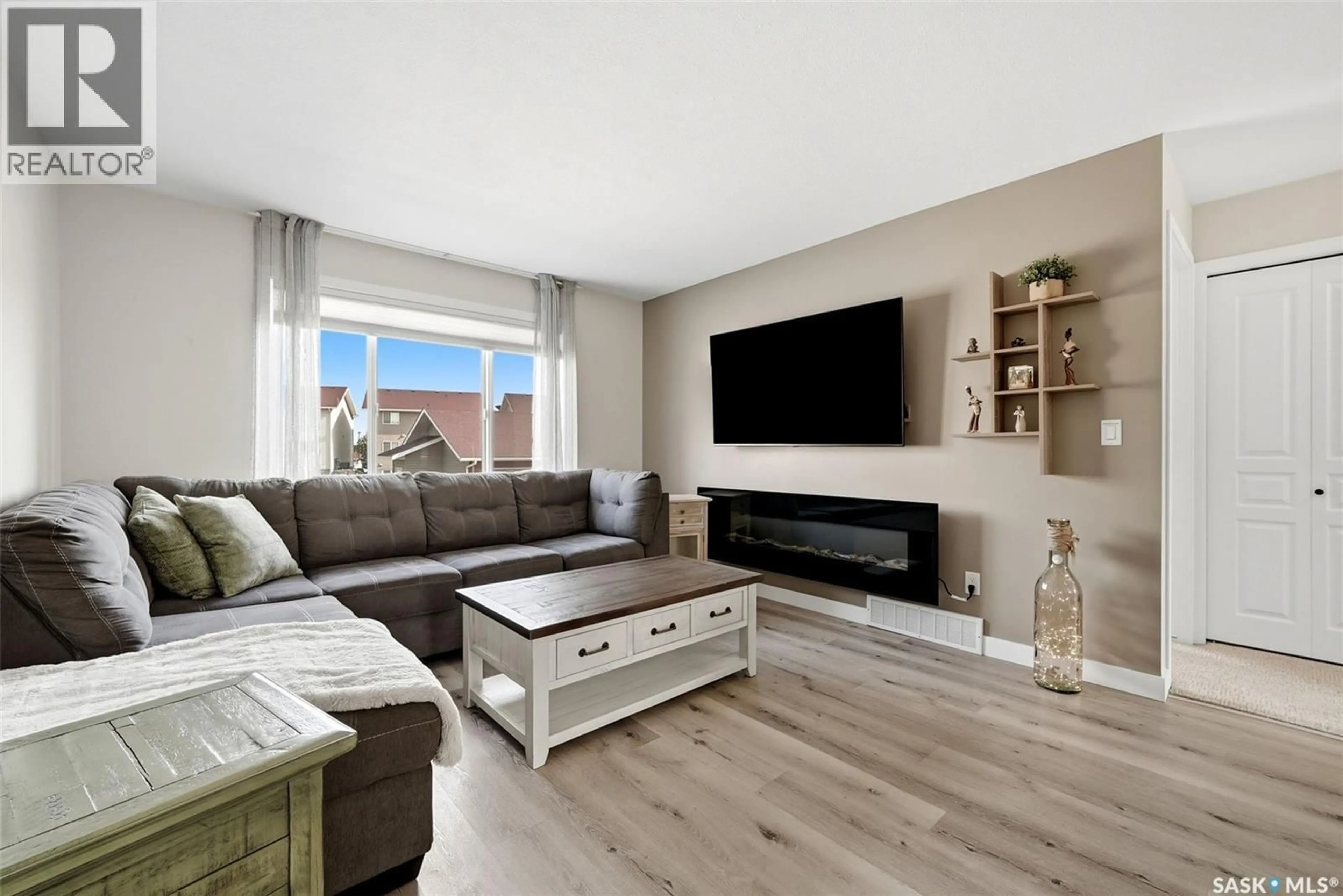 Living room with furniture, wood/laminate floor for 59 5004 JAMES HILL ROAD, Regina Saskatchewan S4W0E8