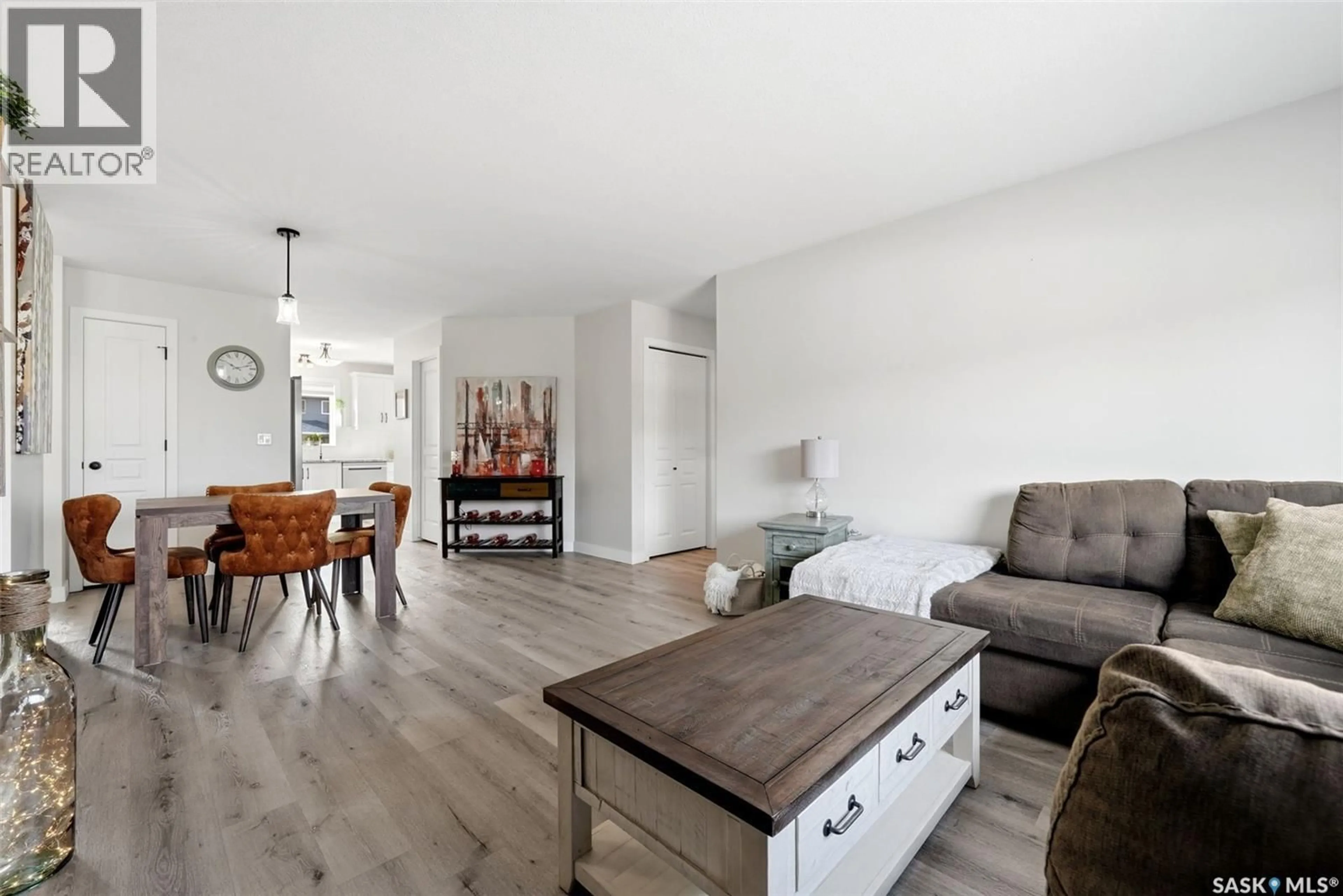 Living room with furniture, wood/laminate floor for 59 5004 JAMES HILL ROAD, Regina Saskatchewan S4W0E8