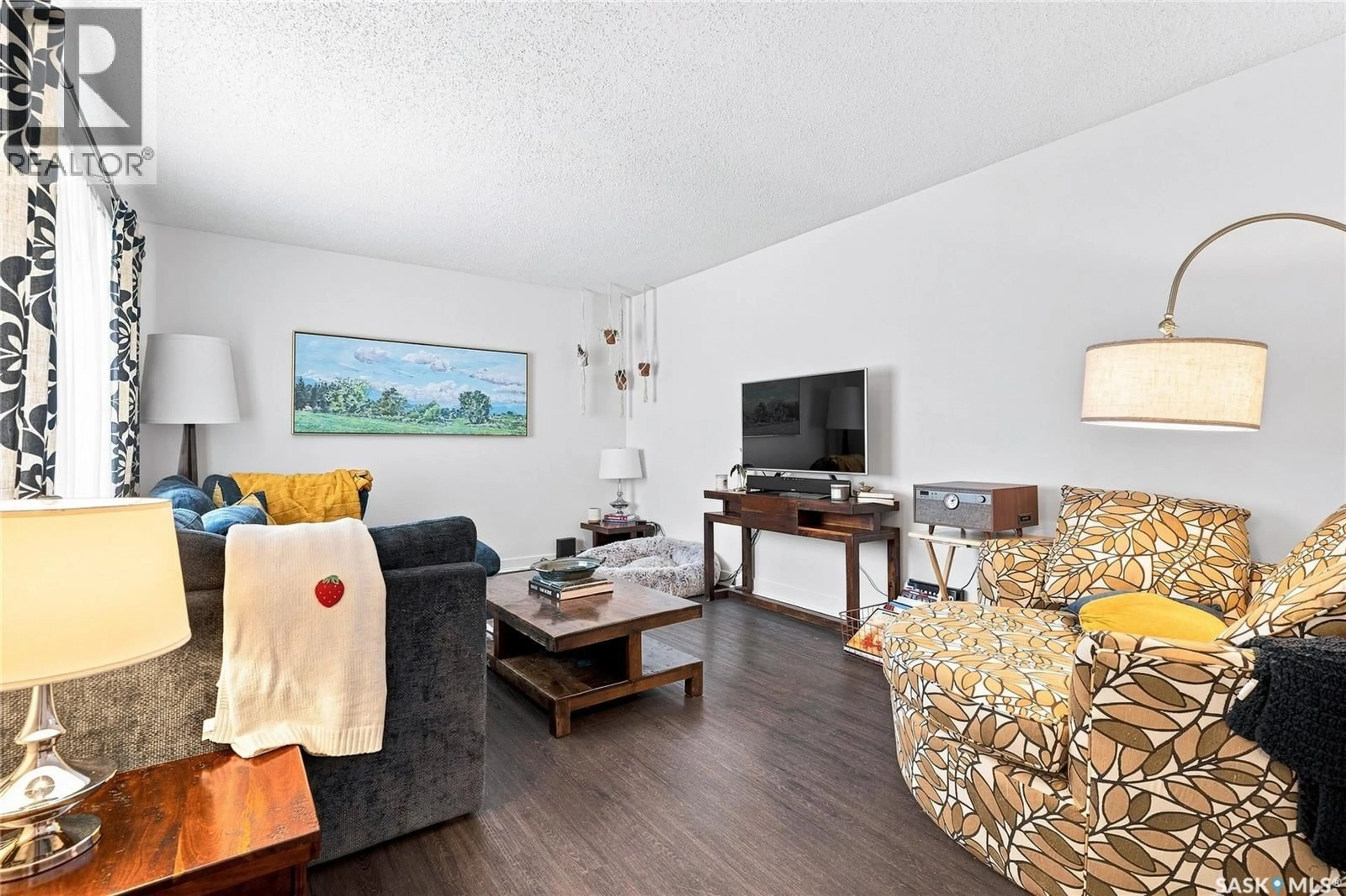 Living room with furniture, wood/laminate floor for 301 CASCADE STREET, Saskatoon Saskatchewan S7J0M4