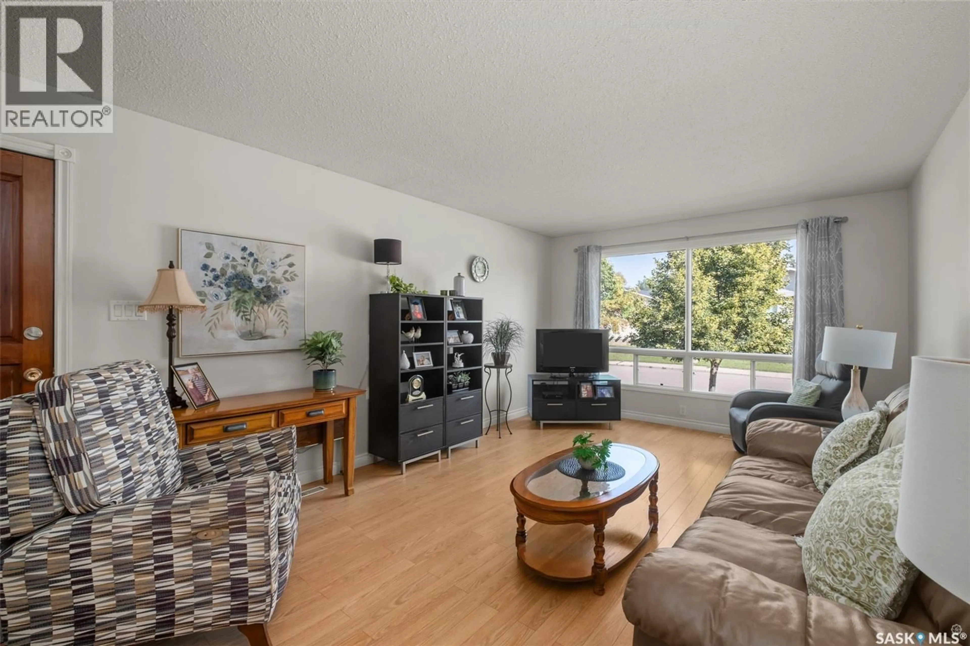 Living room with furniture, wood/laminate floor for 21 PLAXTON PLACE, Prince Albert Saskatchewan S6V6N6