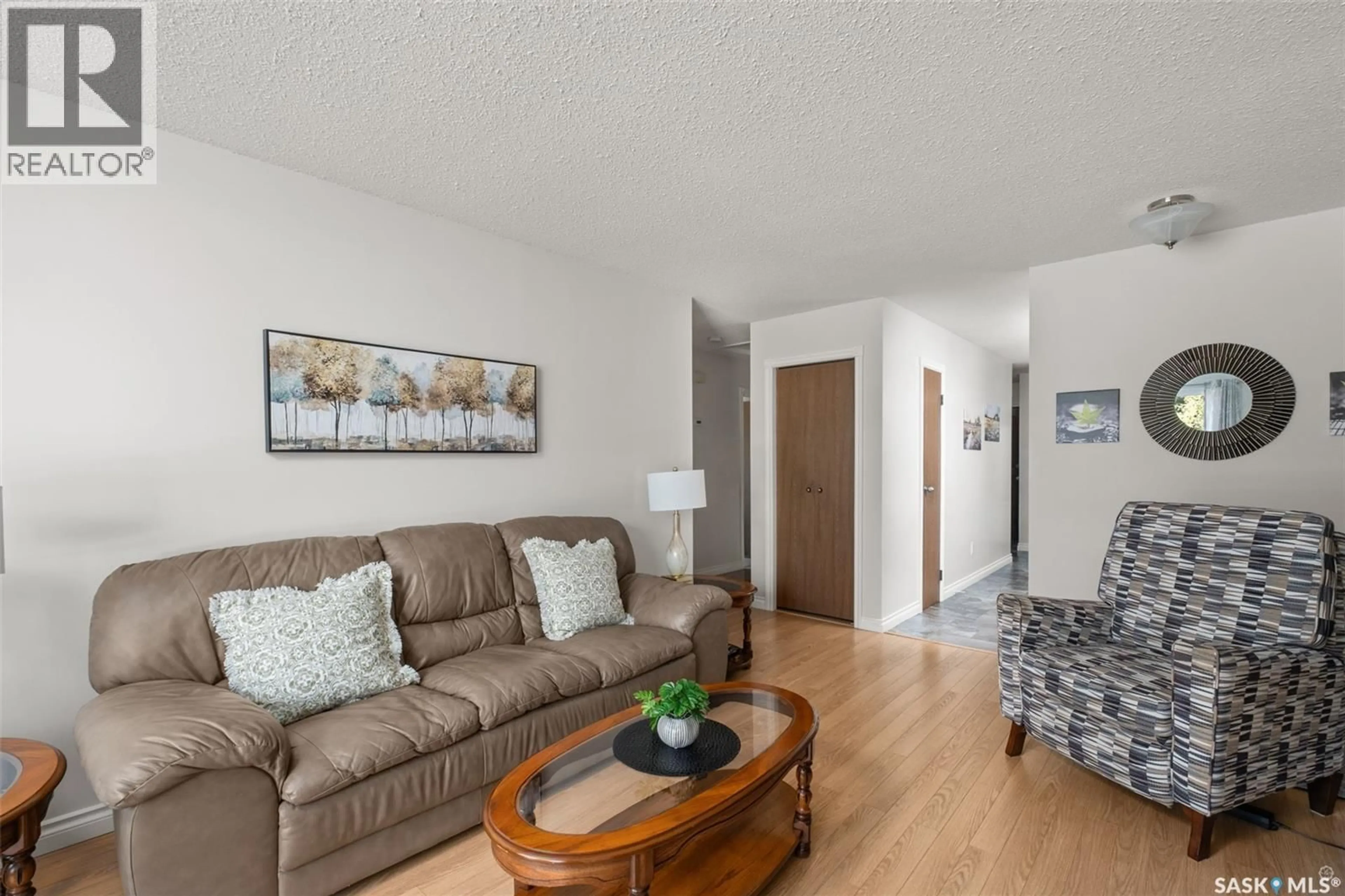 Living room with furniture, wood/laminate floor for 21 PLAXTON PLACE, Prince Albert Saskatchewan S6V6N6