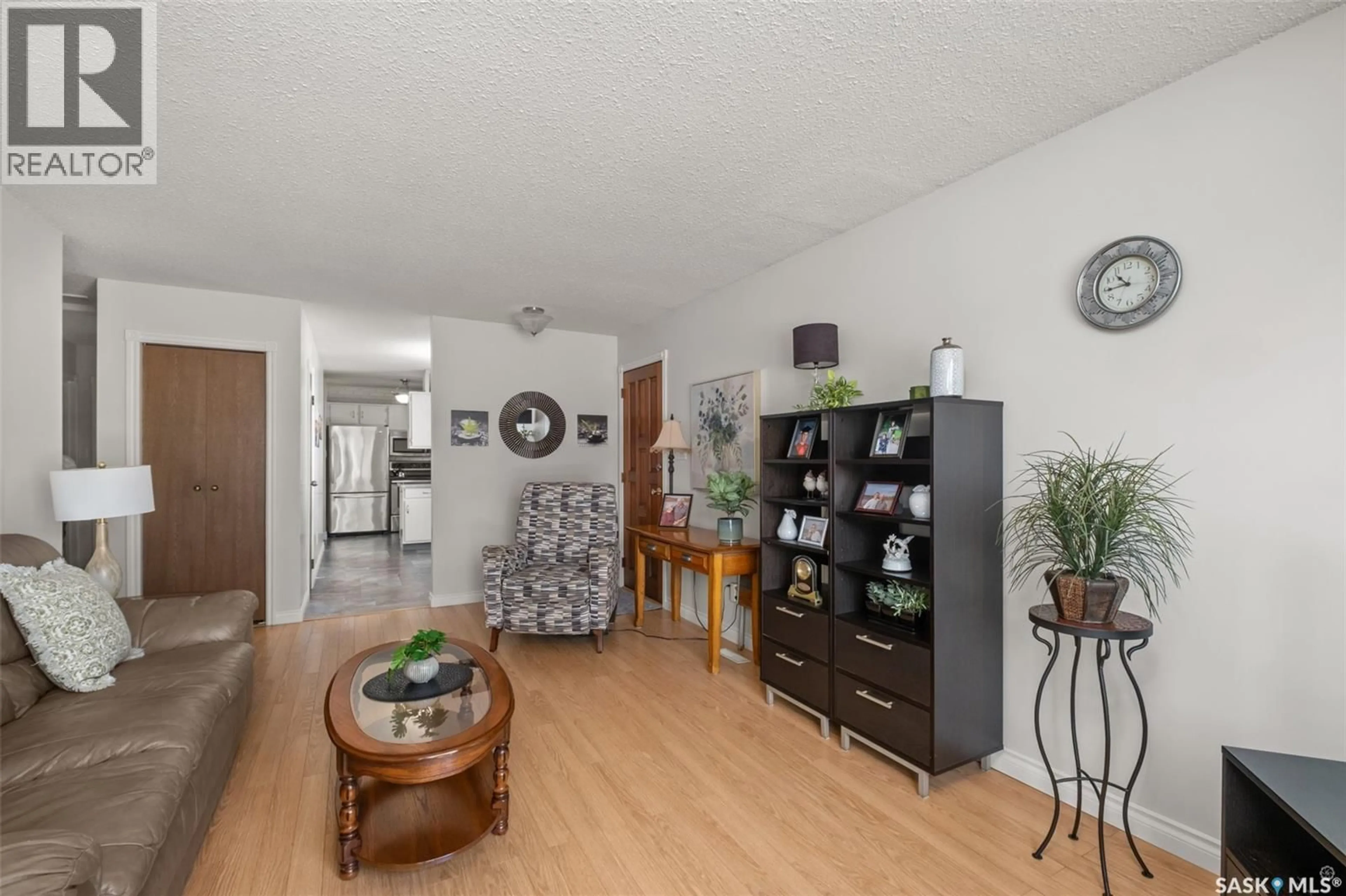Living room with furniture, wood/laminate floor for 21 PLAXTON PLACE, Prince Albert Saskatchewan S6V6N6