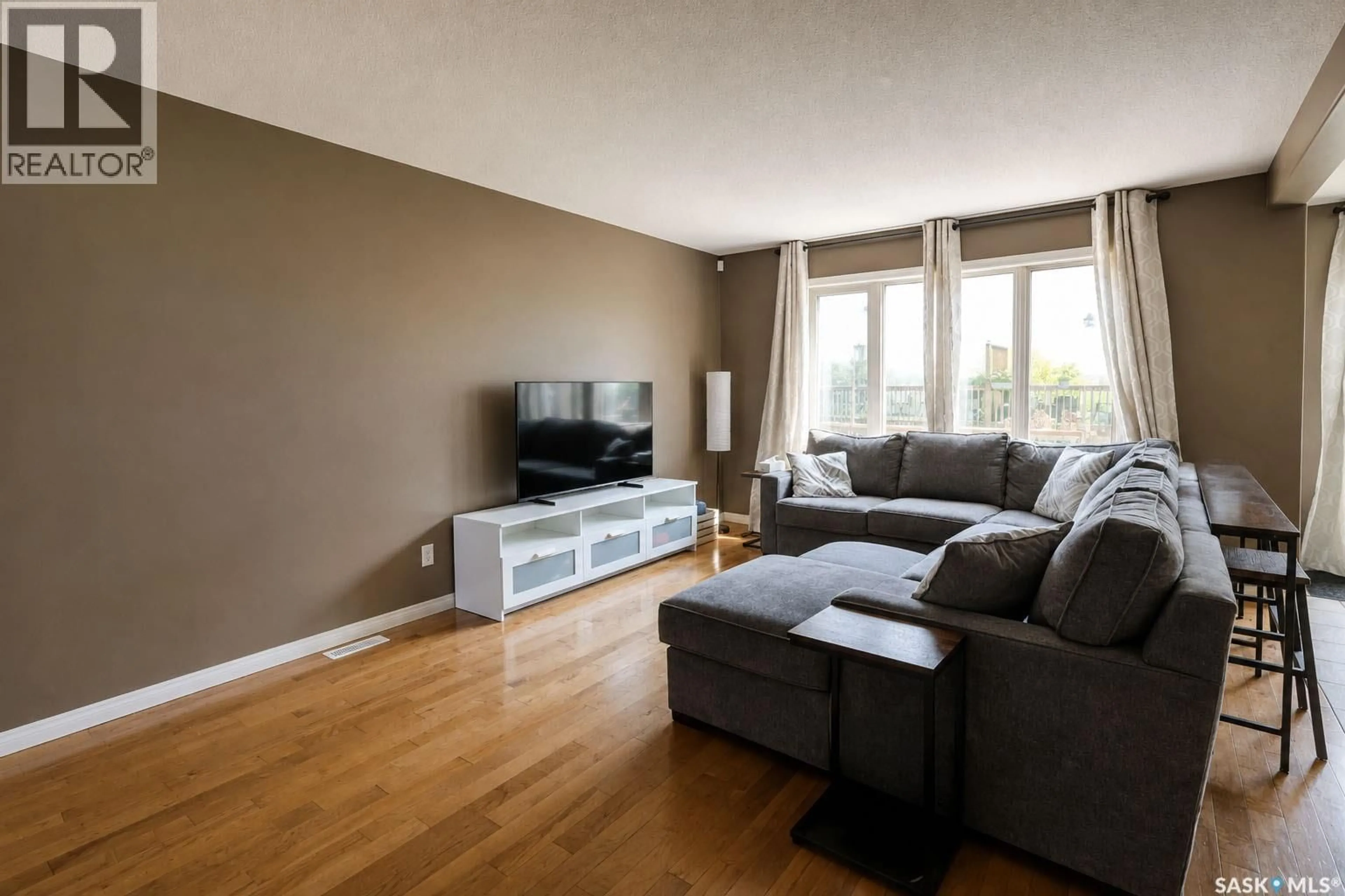 Living room with furniture, wood/laminate floor for 53 1600 MUZZY DRIVE, Prince Albert Saskatchewan S6X0A1