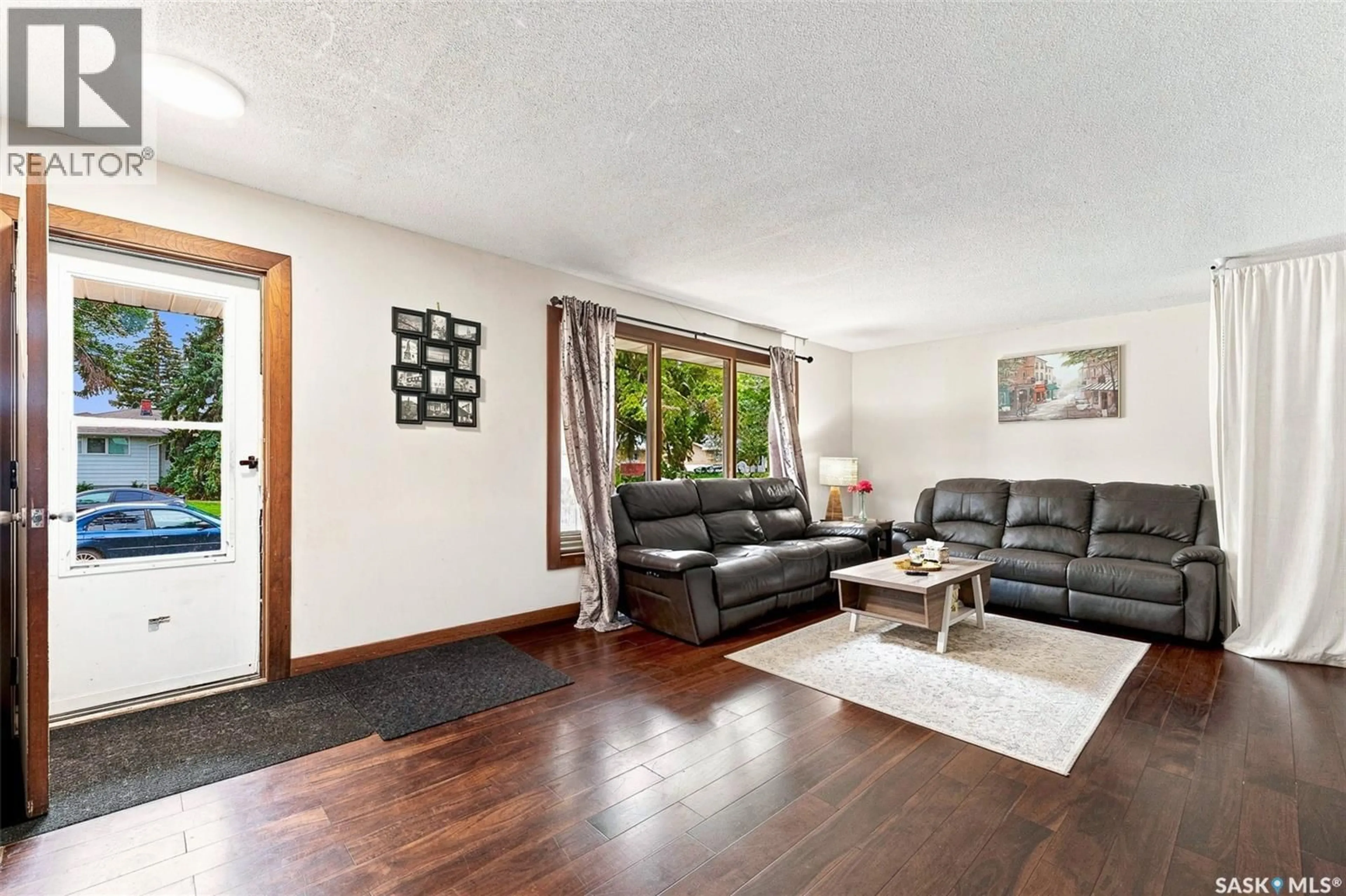 Living room with furniture, wood/laminate floor for 75 CANNON STREET, Regina Saskatchewan S4N1L9