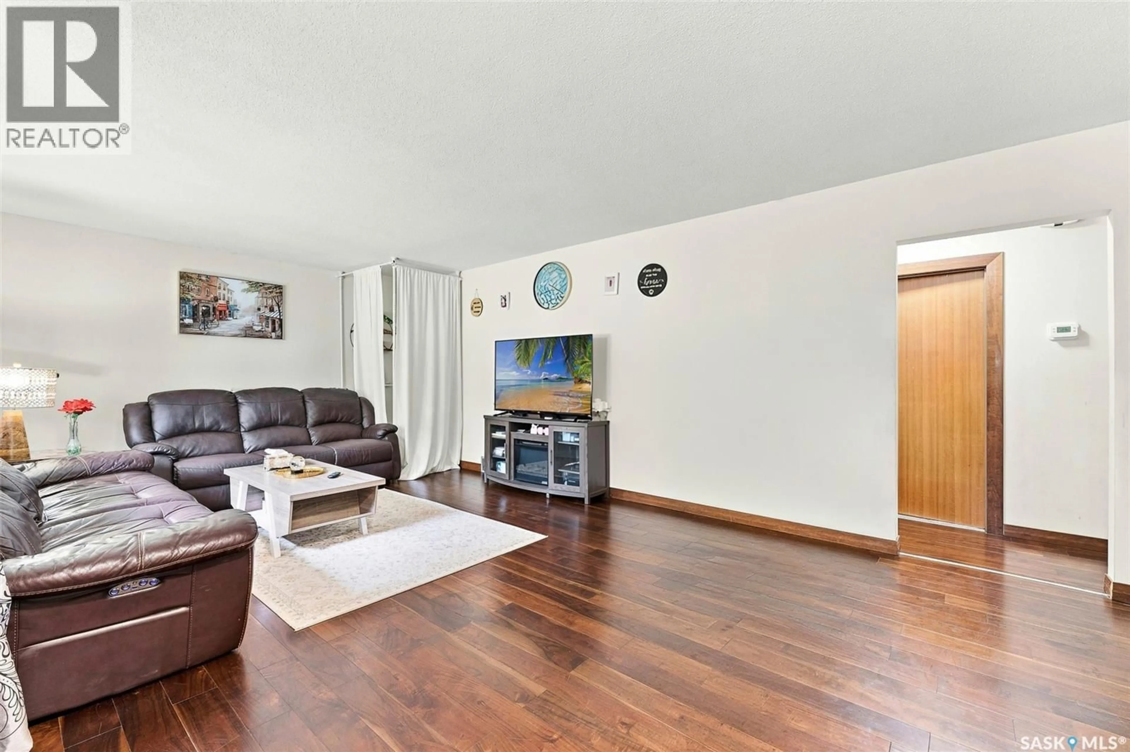 Living room with furniture, wood/laminate floor for 75 CANNON STREET, Regina Saskatchewan S4N1L9