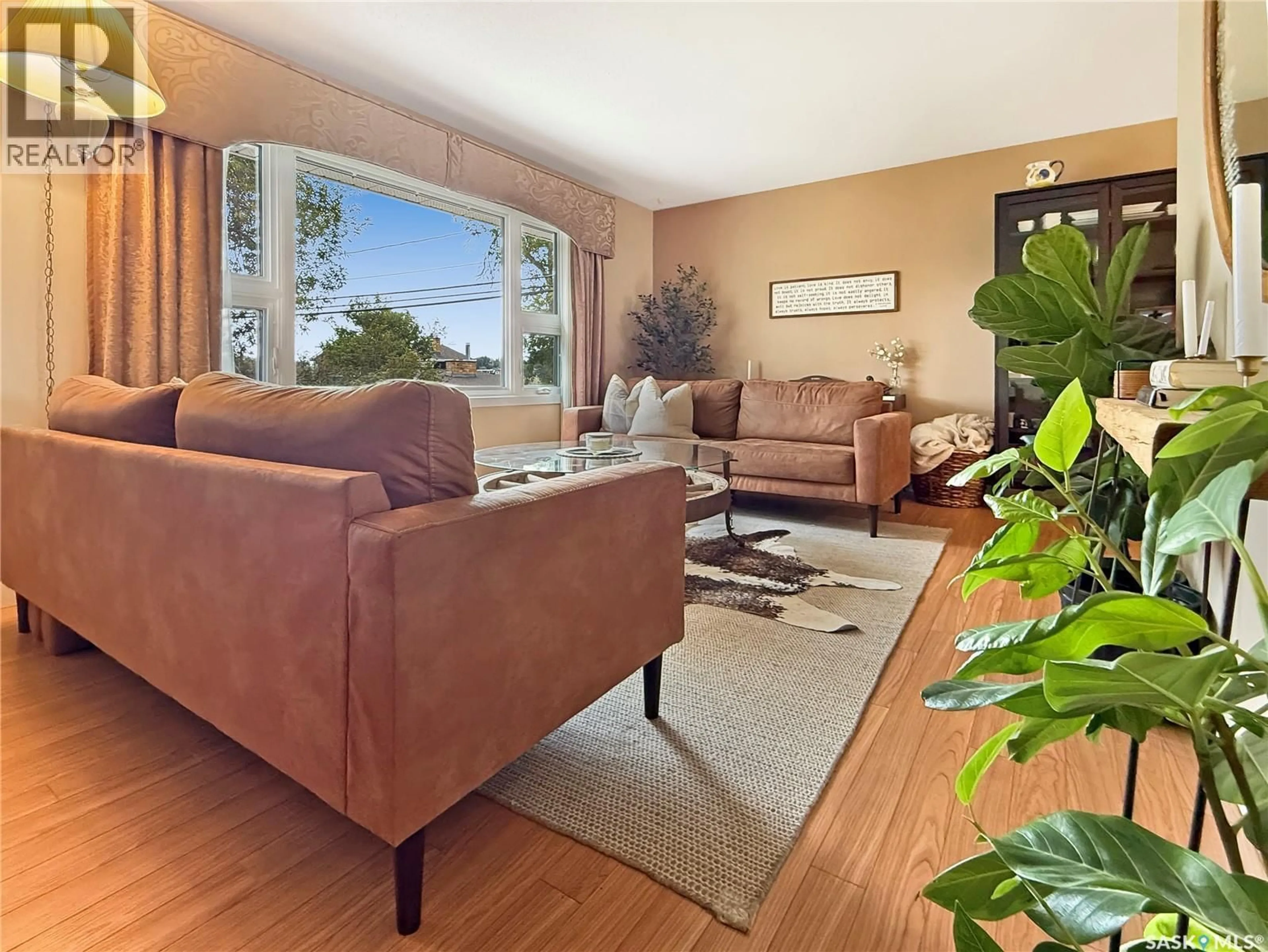 Living room with furniture, wood/laminate floor for 810 11TH AVENUE, Swift Current Saskatchewan S9H2V4
