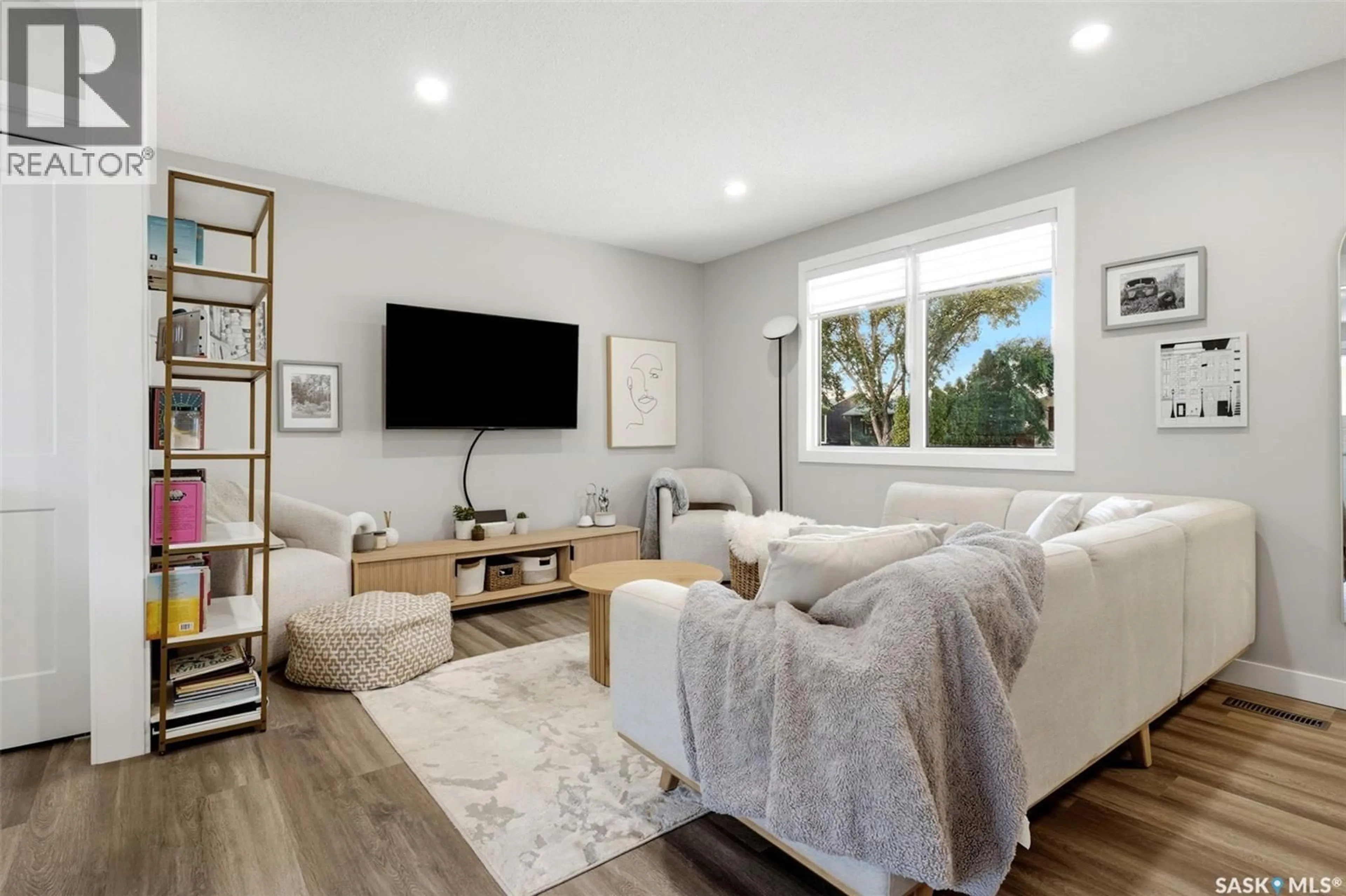 Living room with furniture, wood/laminate floor for 5871 MCKINLEY AVENUE, Regina Saskatchewan S4T6P4