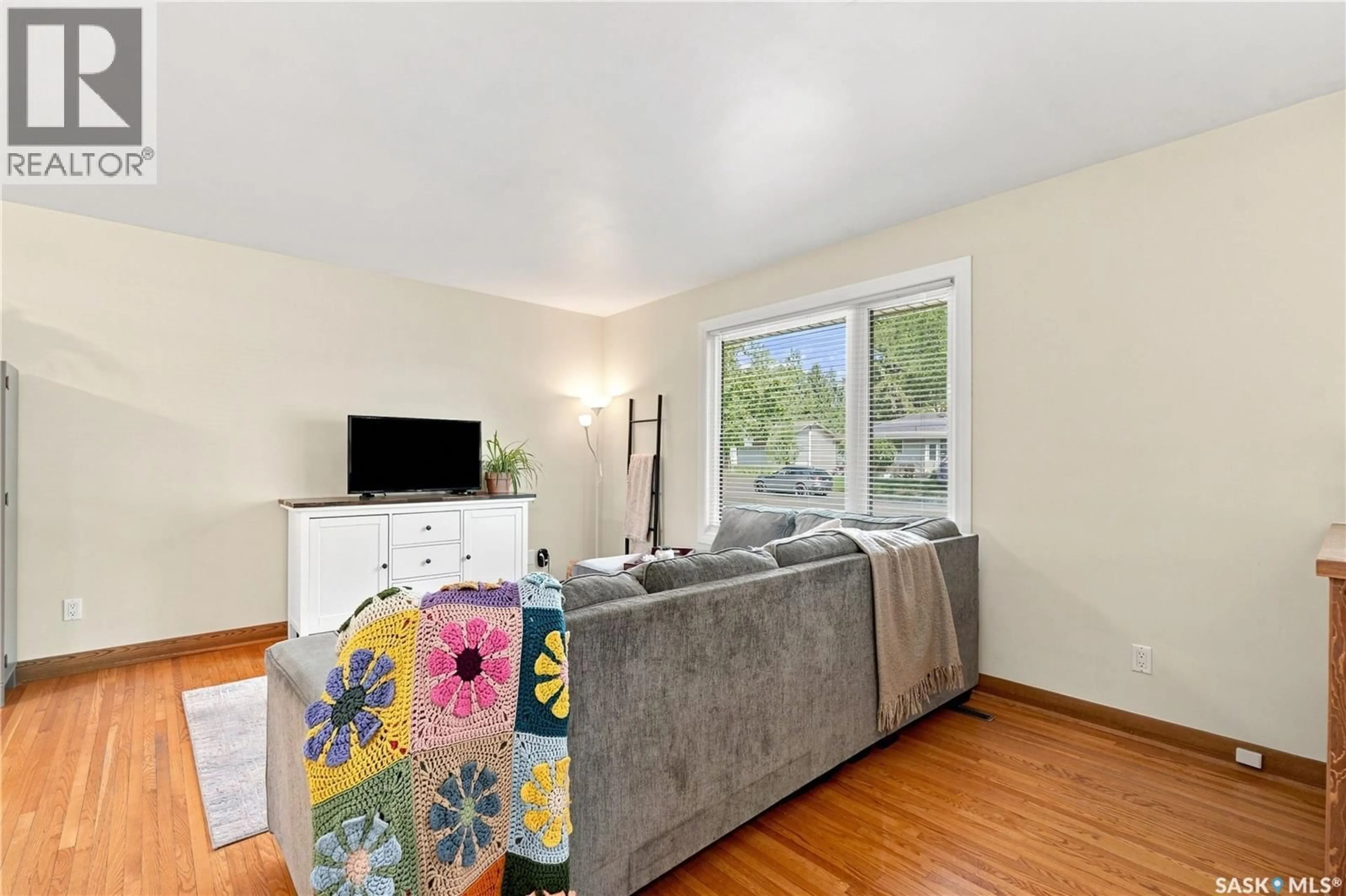 Living room with furniture, wood/laminate floor for 1810 MORGAN AVENUE, Saskatoon Saskatchewan S7H2S3