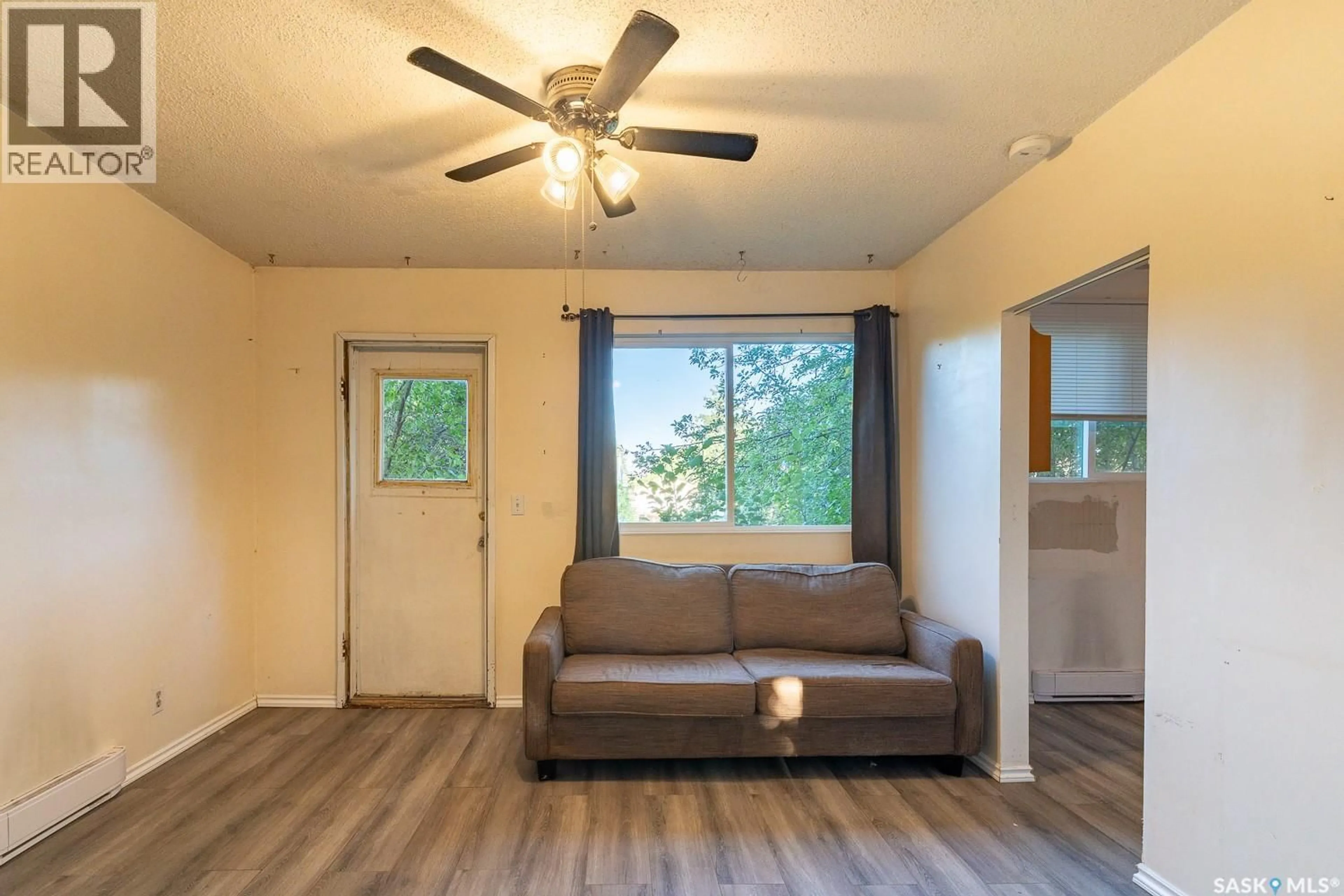 Living room with furniture, wood/laminate floor for 30 1ST AVENUE, Martensville Saskatchewan S0K0A2