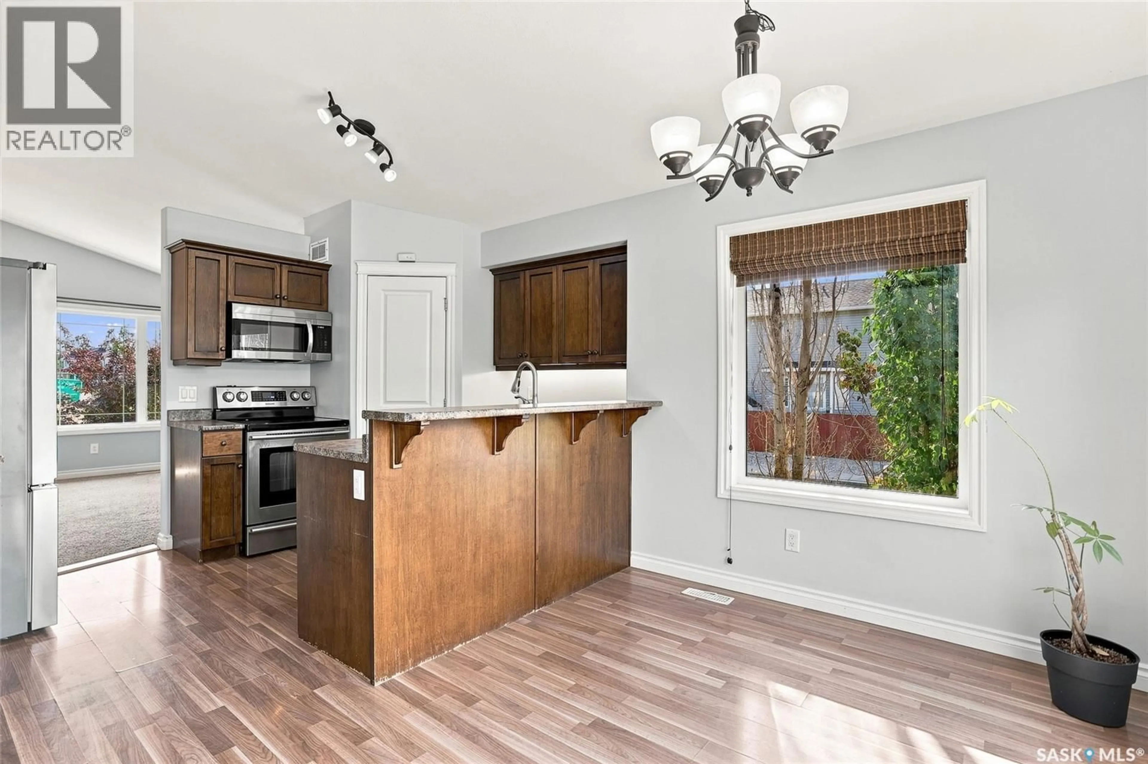 Open concept kitchen, wood/laminate floor for 318 LUCYK CRESCENT, Saskatoon Saskatchewan S7W0E8