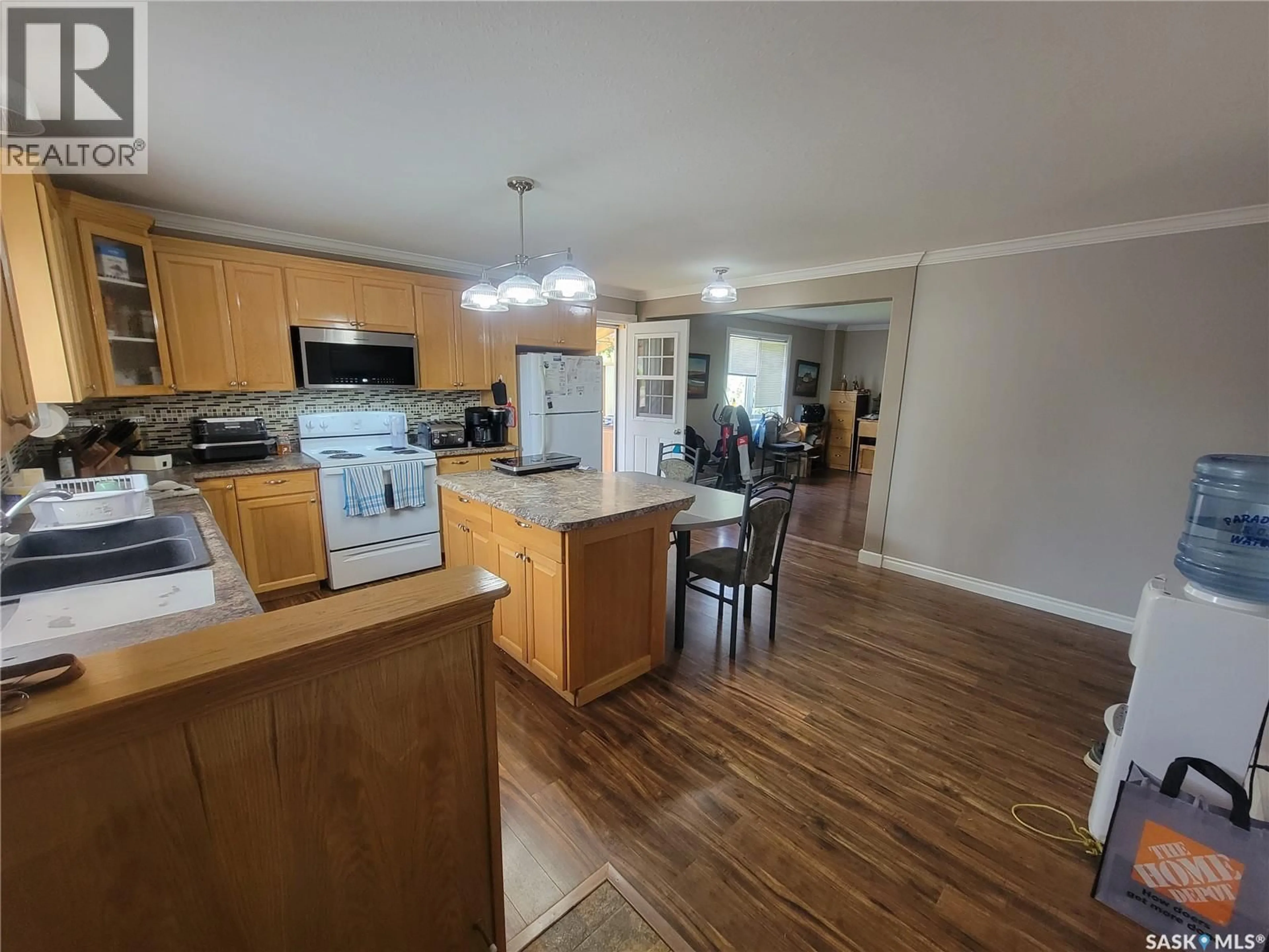Open concept kitchen, wood/laminate floor for 118 2ND STREET, St. Walburg Saskatchewan S0M2T0