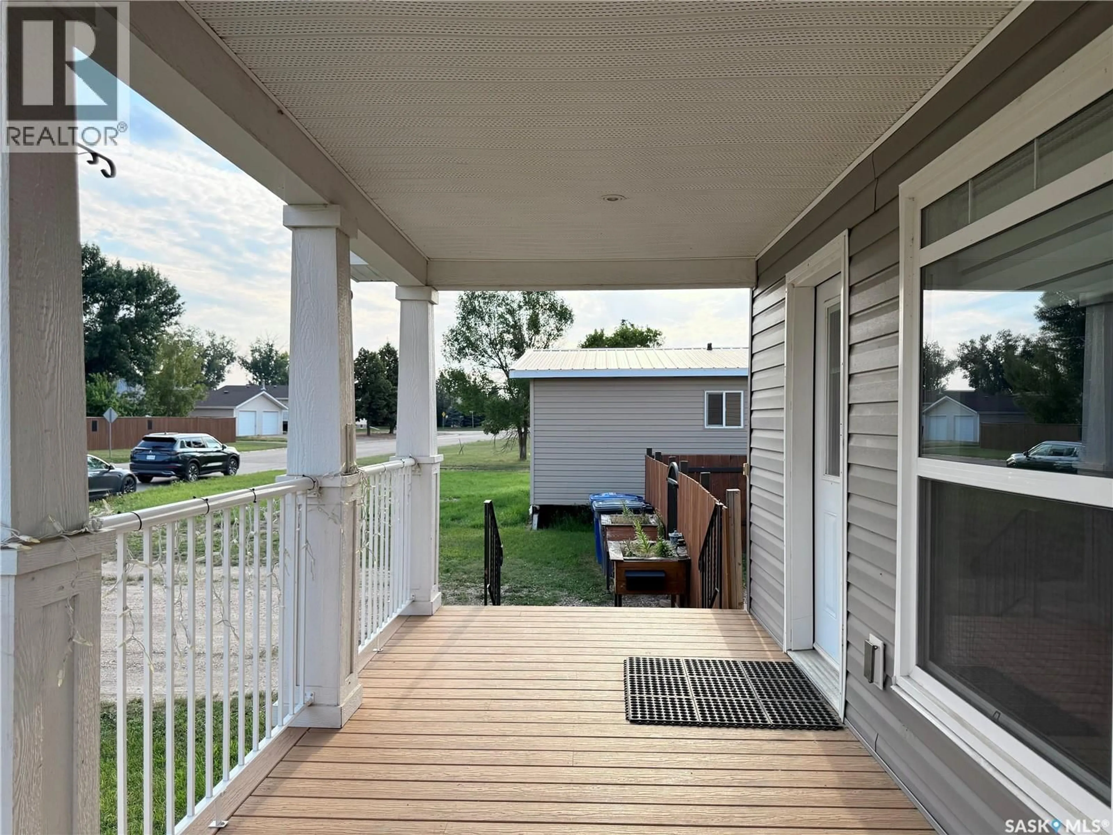 Home with vinyl exterior material, street for 702 PRAIRIE AVENUE, Outlook Saskatchewan S0L2N0