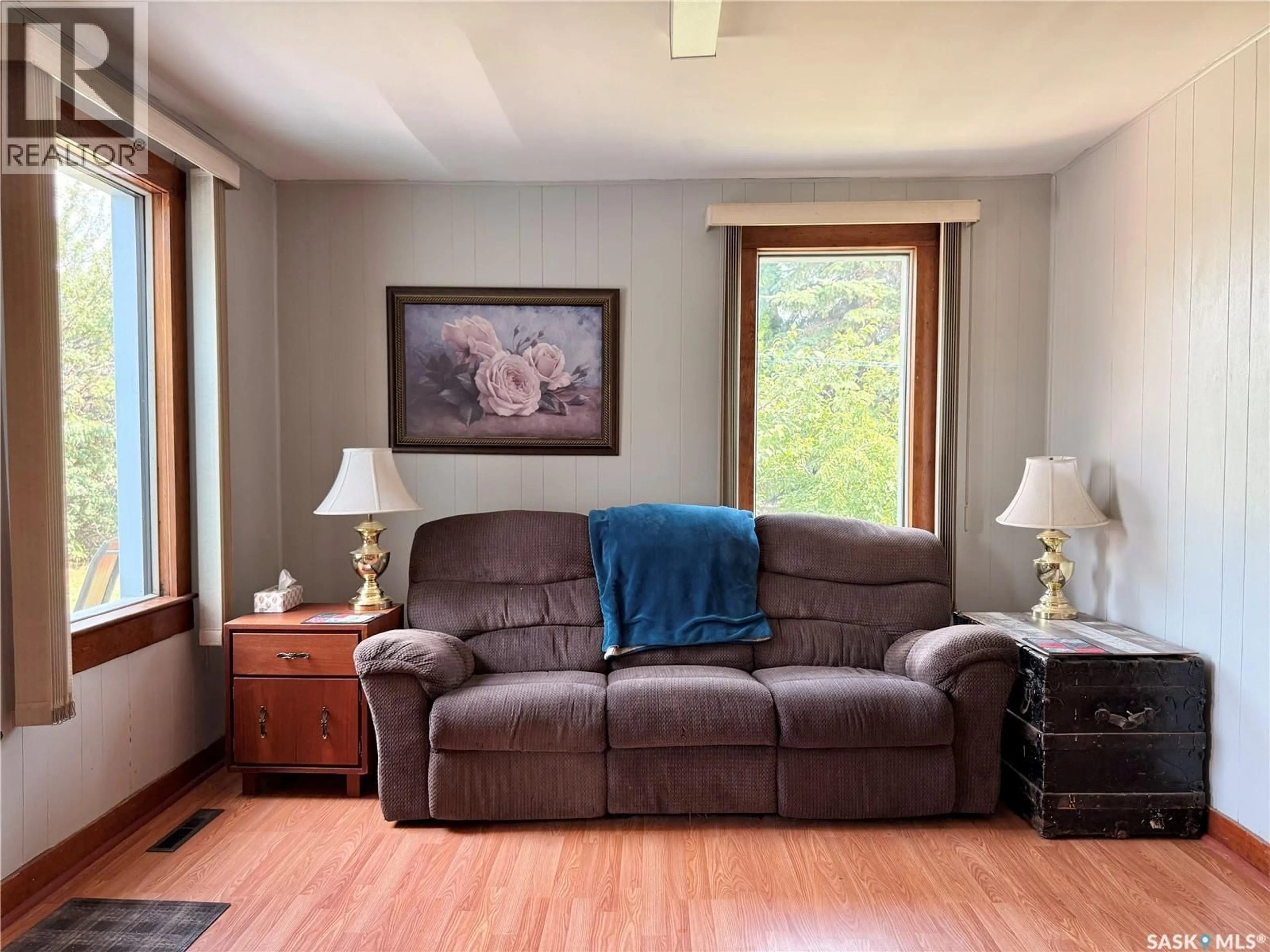 Living room with furniture, wood/laminate floor for 309 RAILWAY AVENUE, Outlook Saskatchewan S0L2N0
