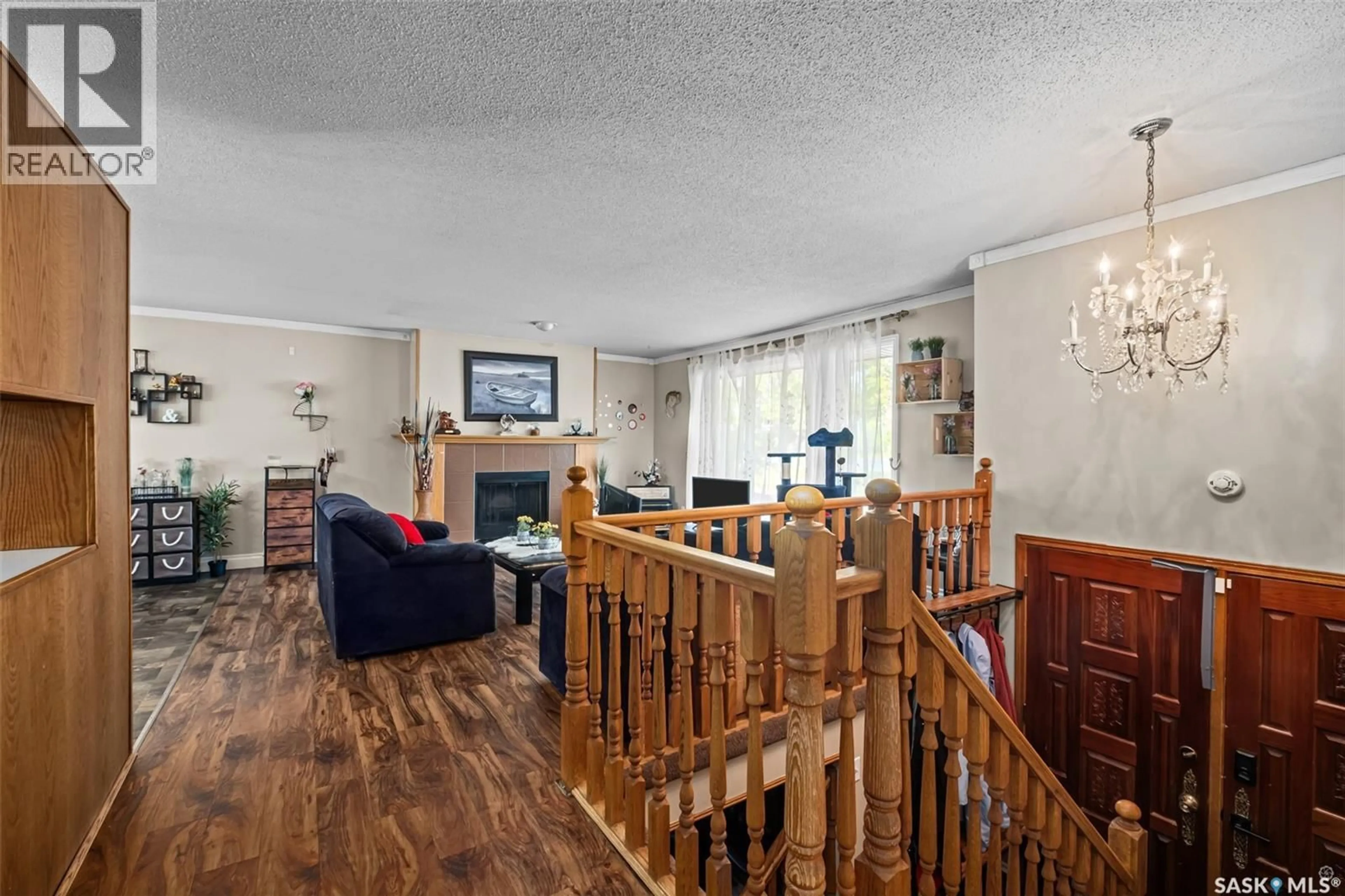Living room with furniture, wood/laminate floor for 1359 RIVER STREET, Prince Albert Saskatchewan S6V0B8
