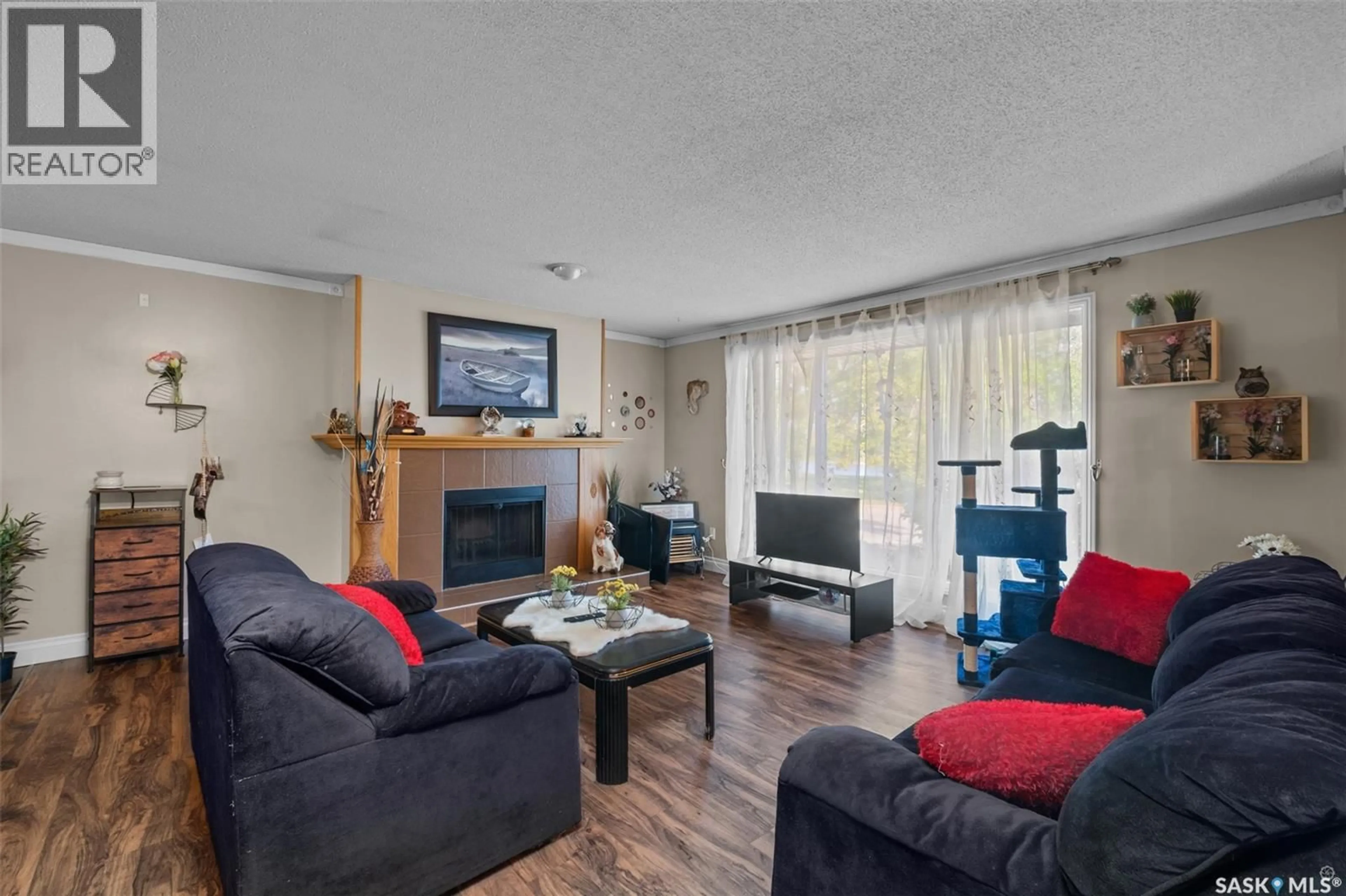 Living room with furniture, wood/laminate floor for 1359 RIVER STREET, Prince Albert Saskatchewan S6V0B8