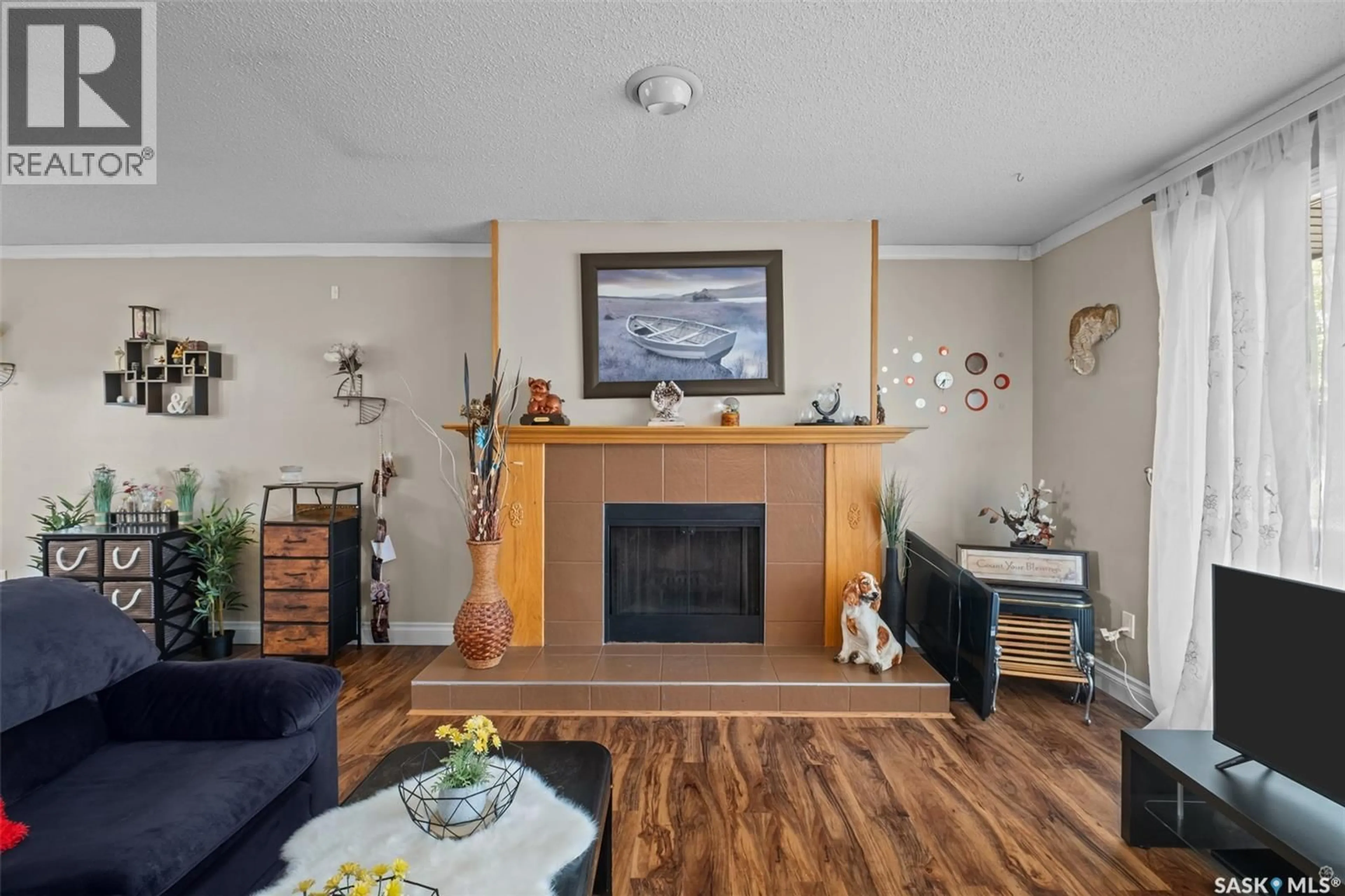 Living room with furniture, wood/laminate floor for 1359 RIVER STREET, Prince Albert Saskatchewan S6V0B8