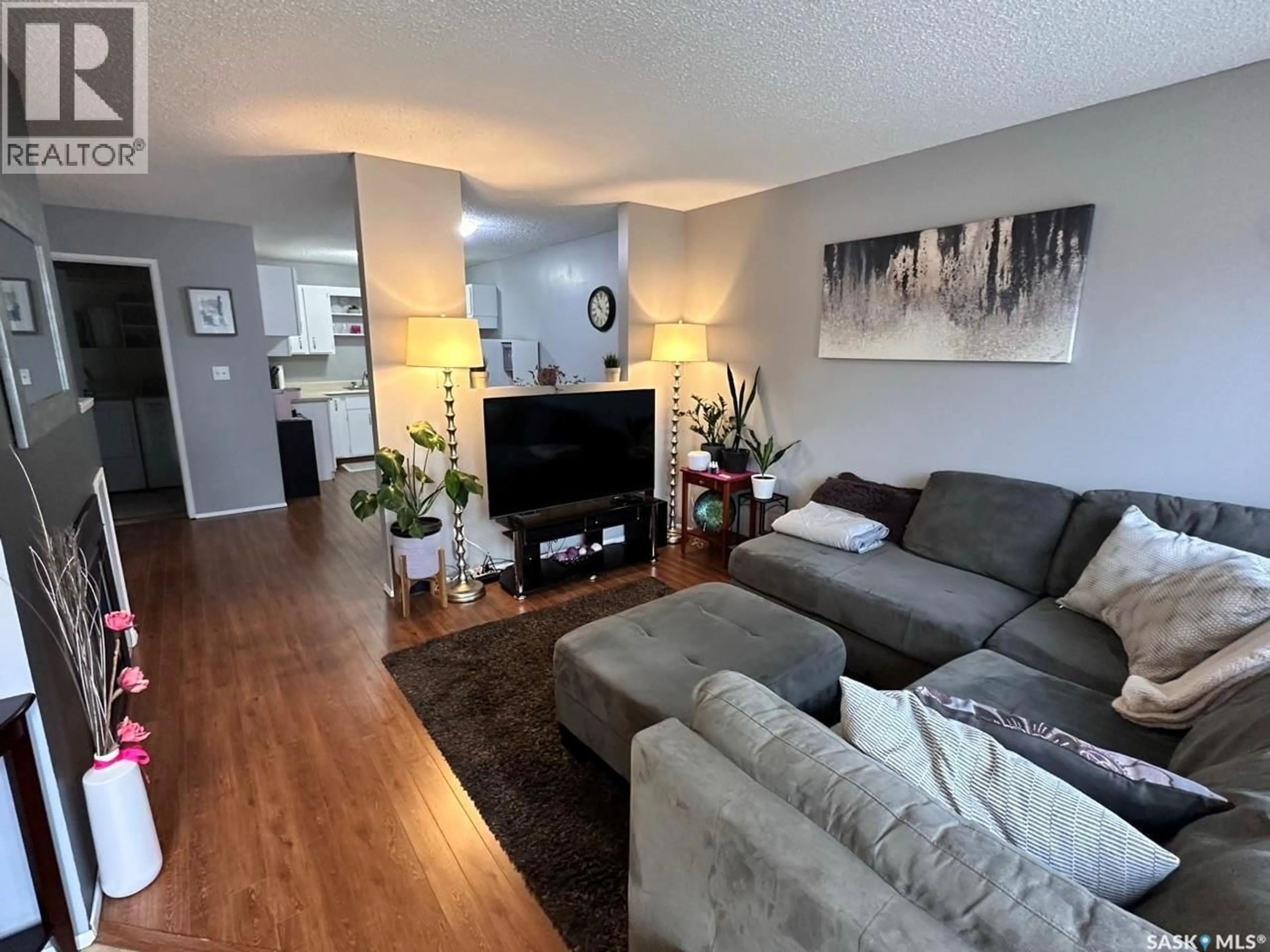 Living room with furniture, wood/laminate floor for 7346 BENNETT DRIVE, Regina Saskatchewan S4X2V3
