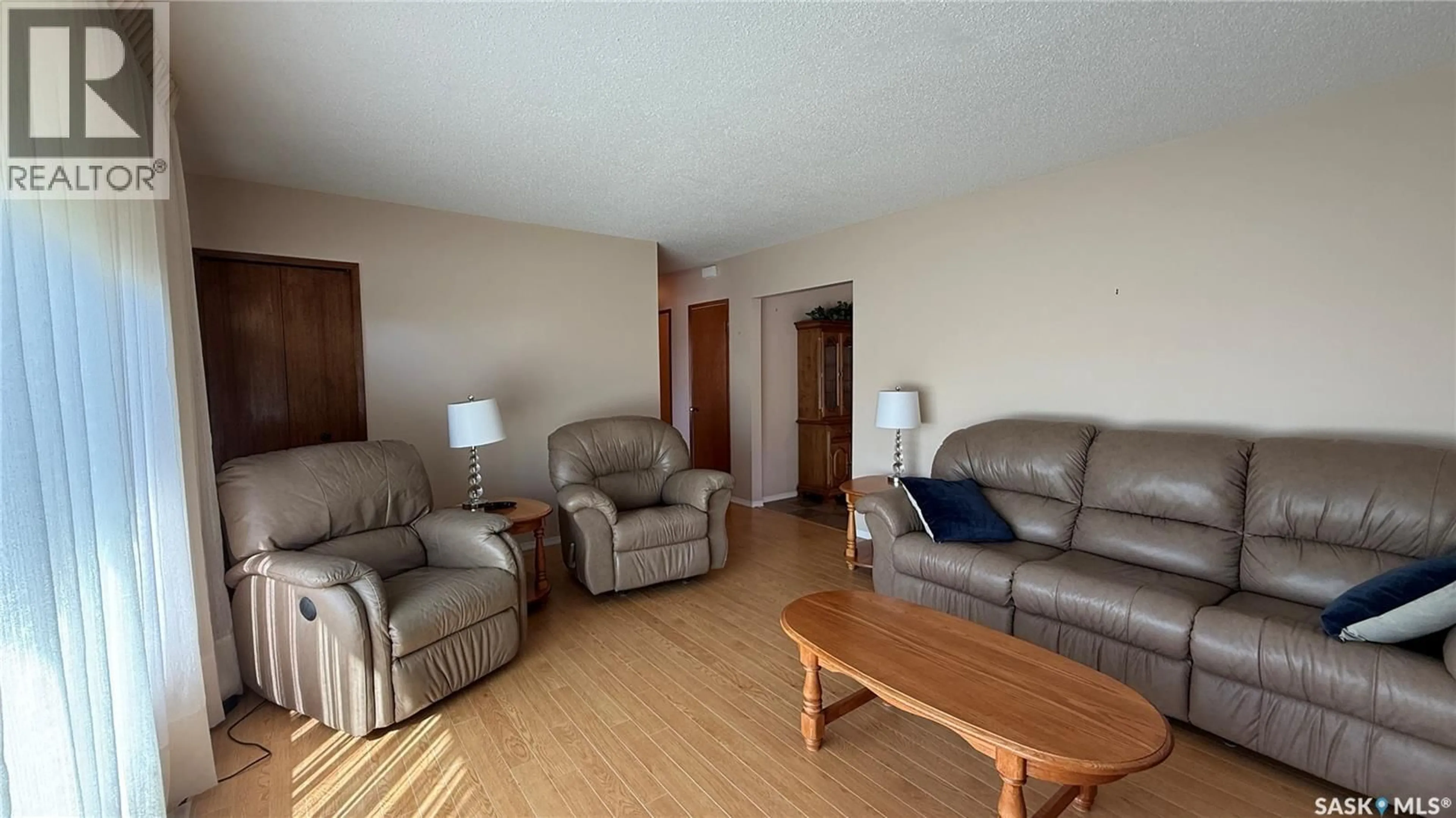 Living room with furniture, wood/laminate floor for 224 HUDEK AVENUE, Hafford Saskatchewan S0J0G4