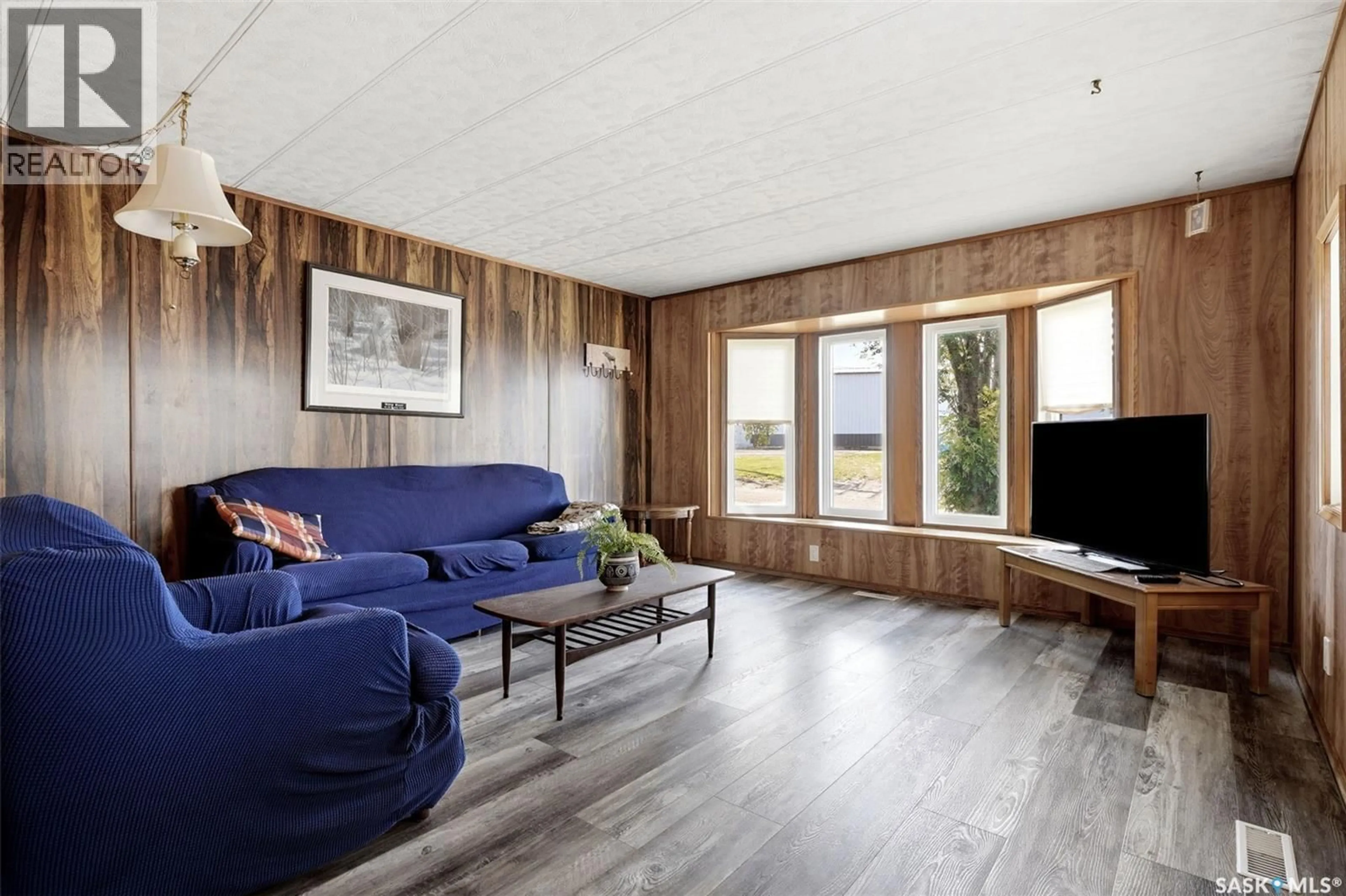 Living room with furniture, wood/laminate floor for 226 1ST AVENUE, Ituna Saskatchewan S0A1N0