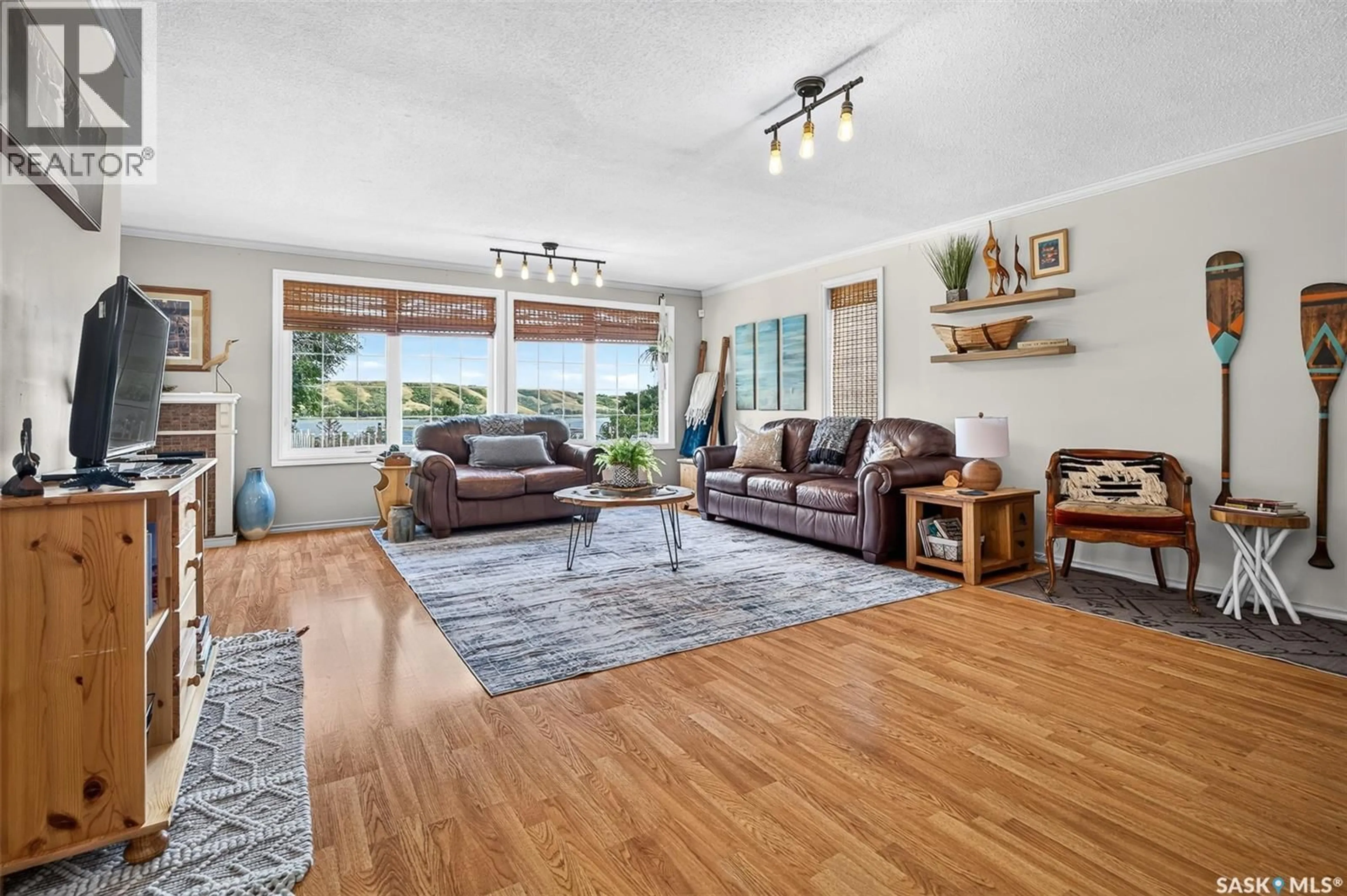Living room with furniture, wood/laminate floor for 101-109 SAND POINT ROAD, Buffalo Pound Lake Saskatchewan S0G4C0