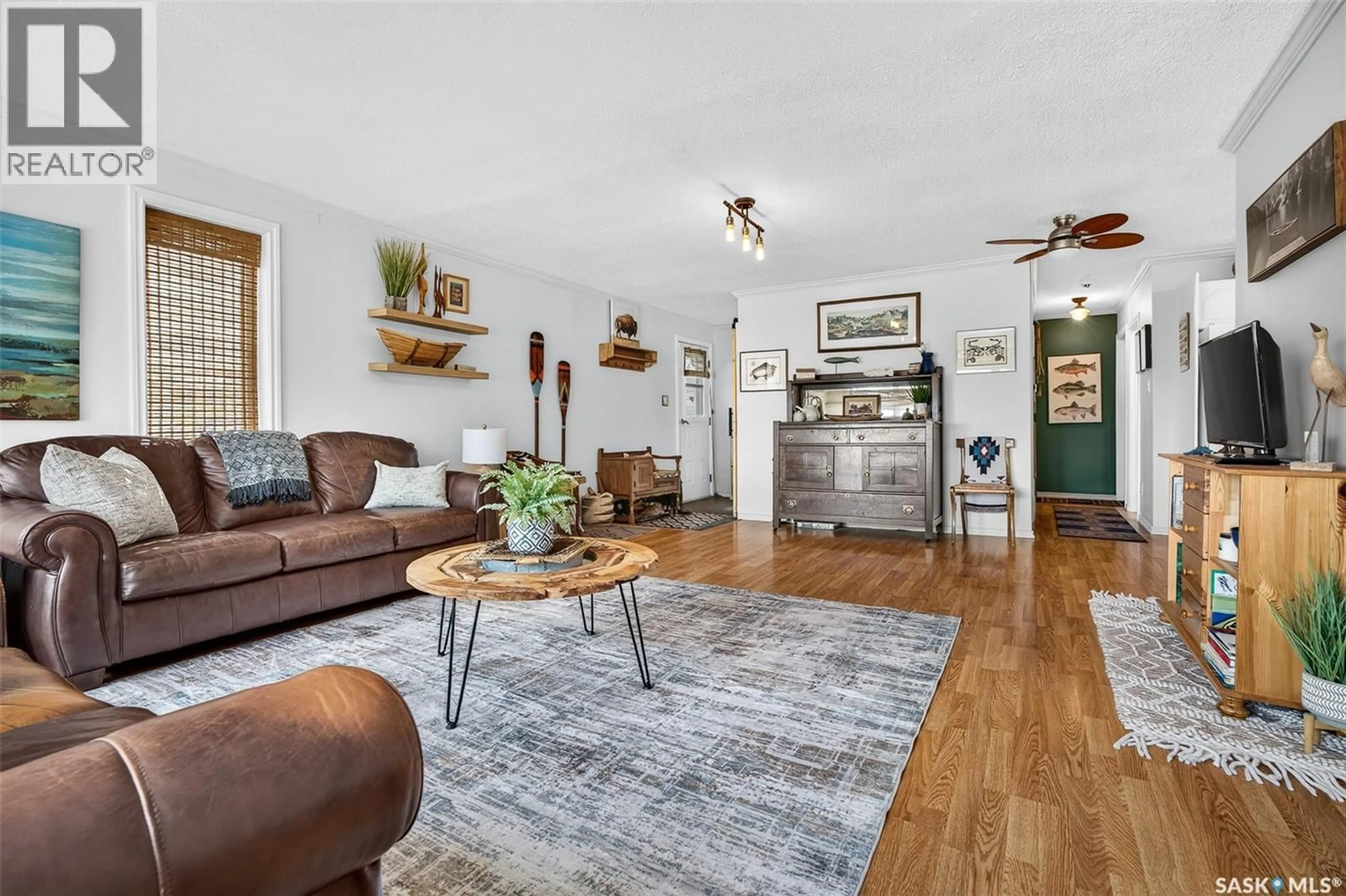 Living room with furniture, wood/laminate floor for 101-109 SAND POINT ROAD, Buffalo Pound Lake Saskatchewan S0G4C0