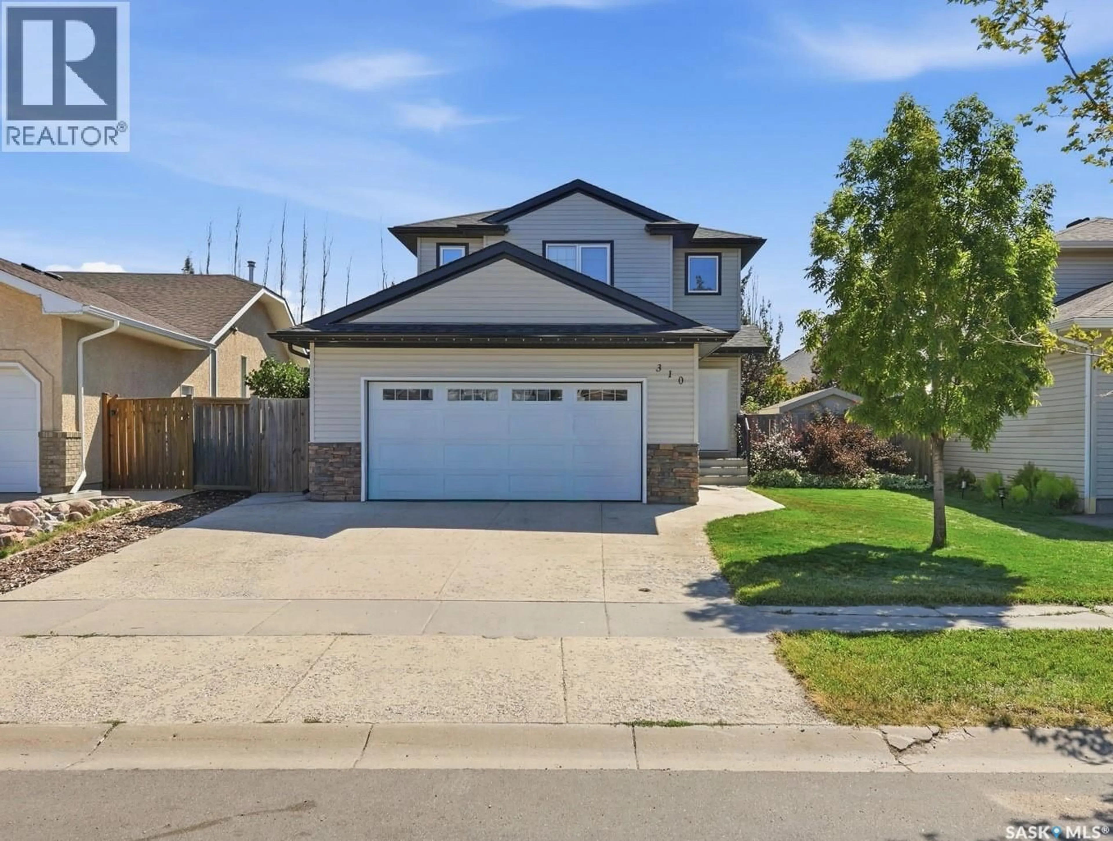 Home with vinyl exterior material, street for 310 STENSRUD ROAD, Saskatoon Saskatchewan S7W1B4