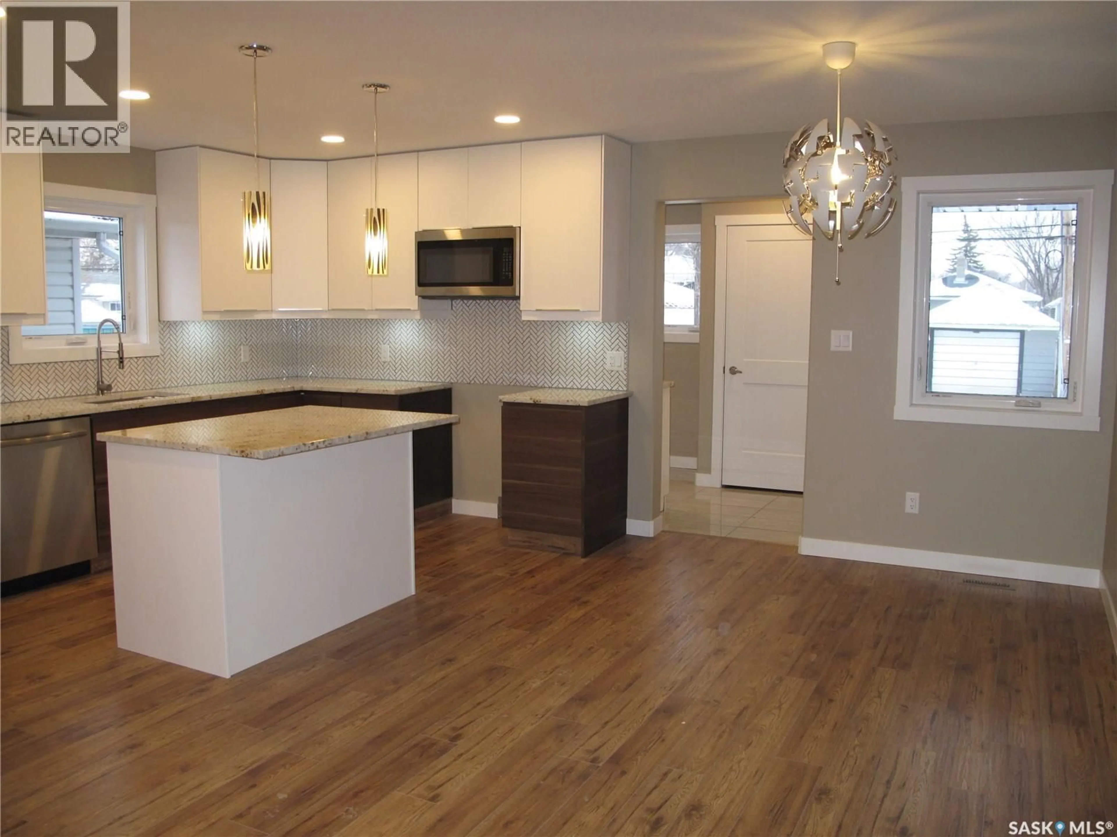 Open concept kitchen, wood/laminate floor for 2261 MCARA STREET, Regina Saskatchewan S4N2W2