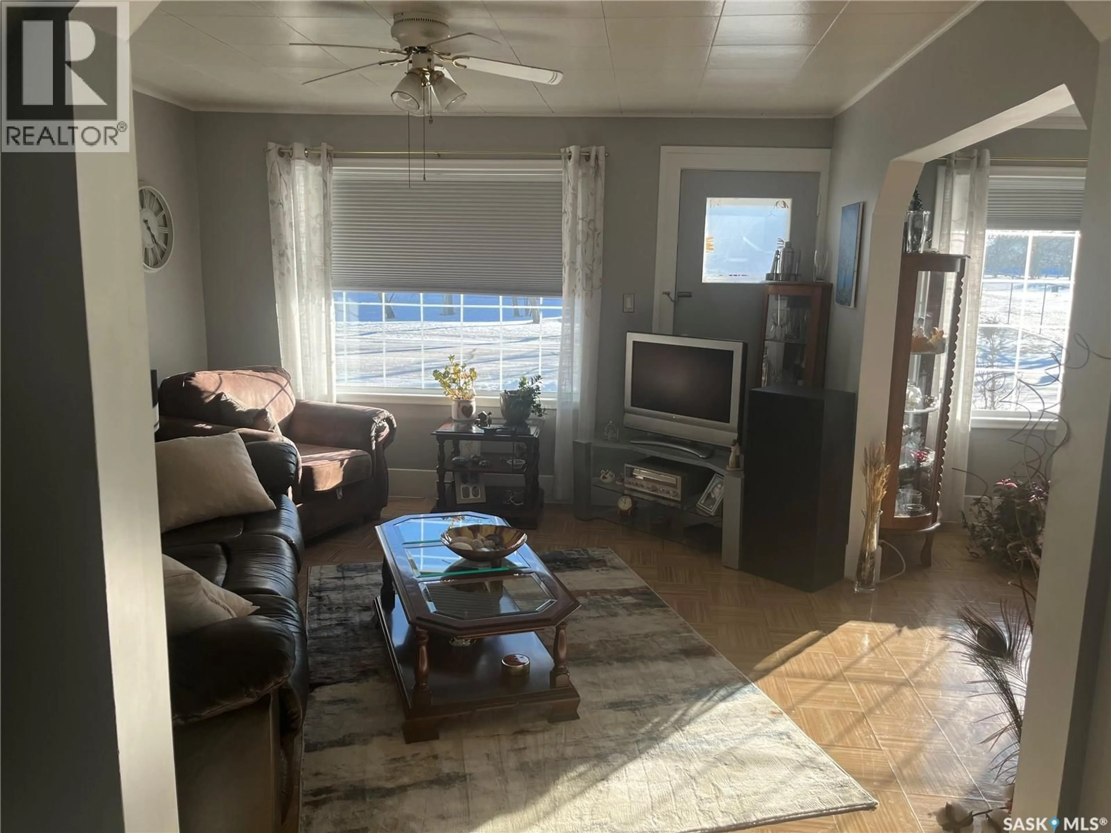 Living room with furniture, wood/laminate floor for 217 7TH AVENUE, Assiniboia Saskatchewan S0H0B0