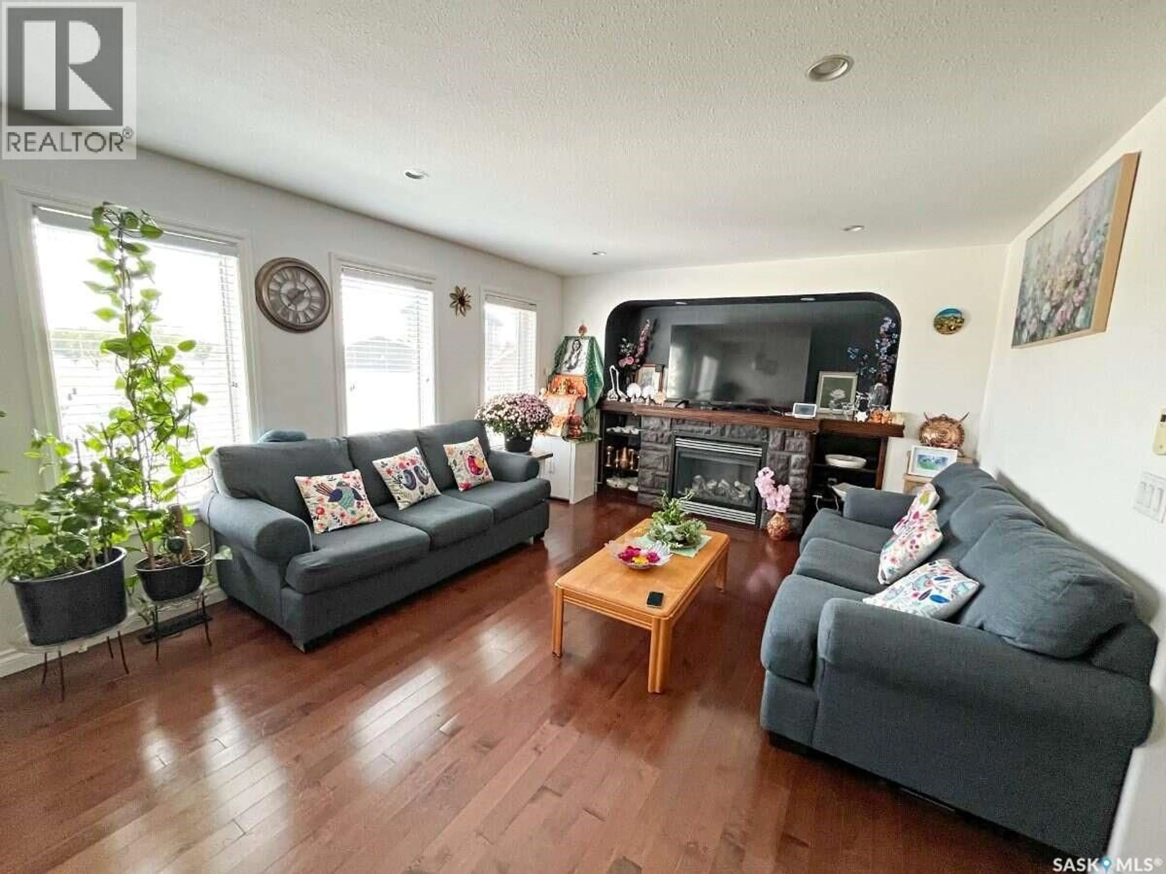 Living room with furniture, wood/laminate floor for 5280 AERIAL CRESCENT, Regina Saskatchewan S4W0C8