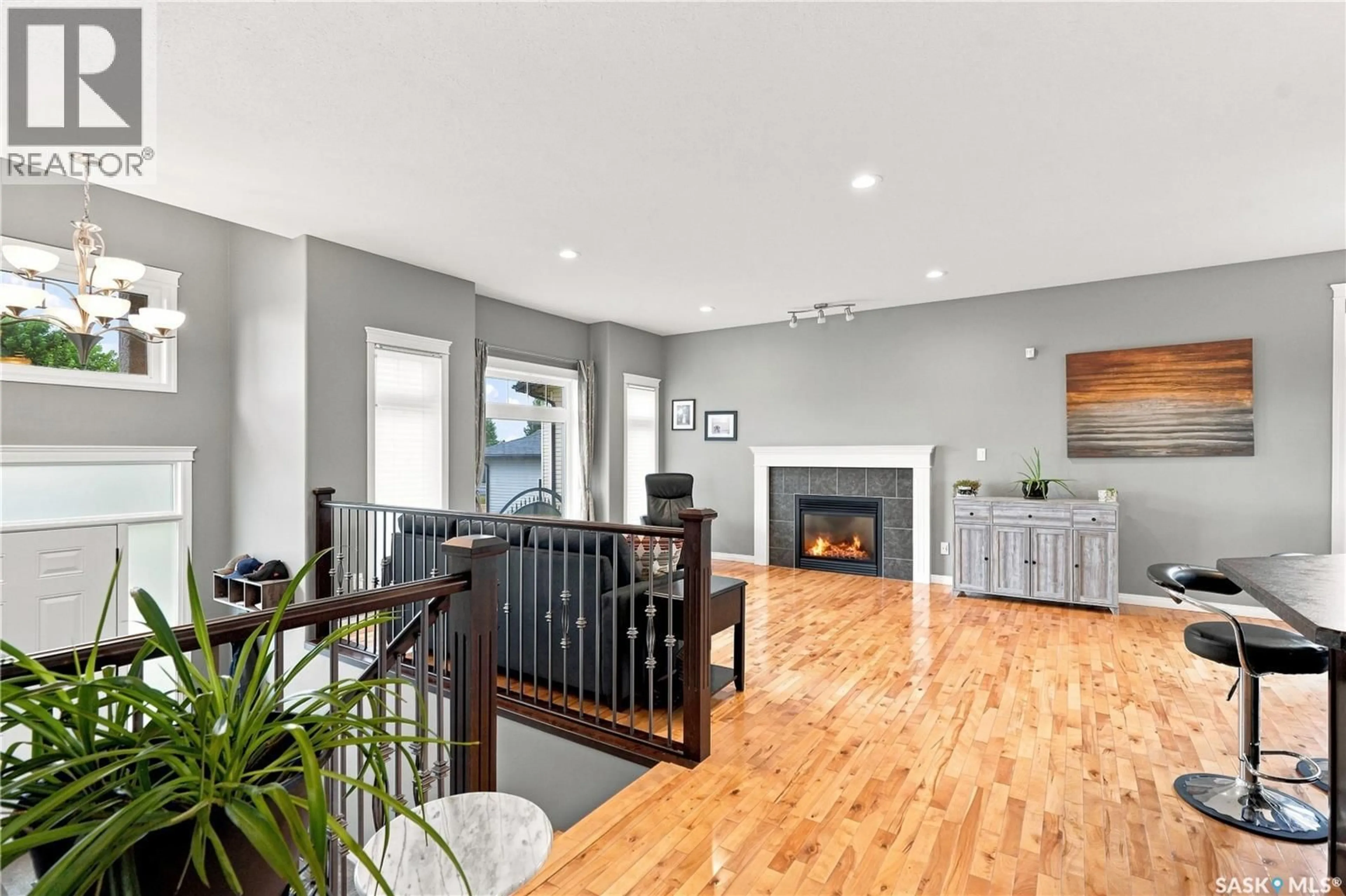 Living room with furniture, wood/laminate floor for 5 BROOKLYN COURT, Warman Saskatchewan S0K0A1