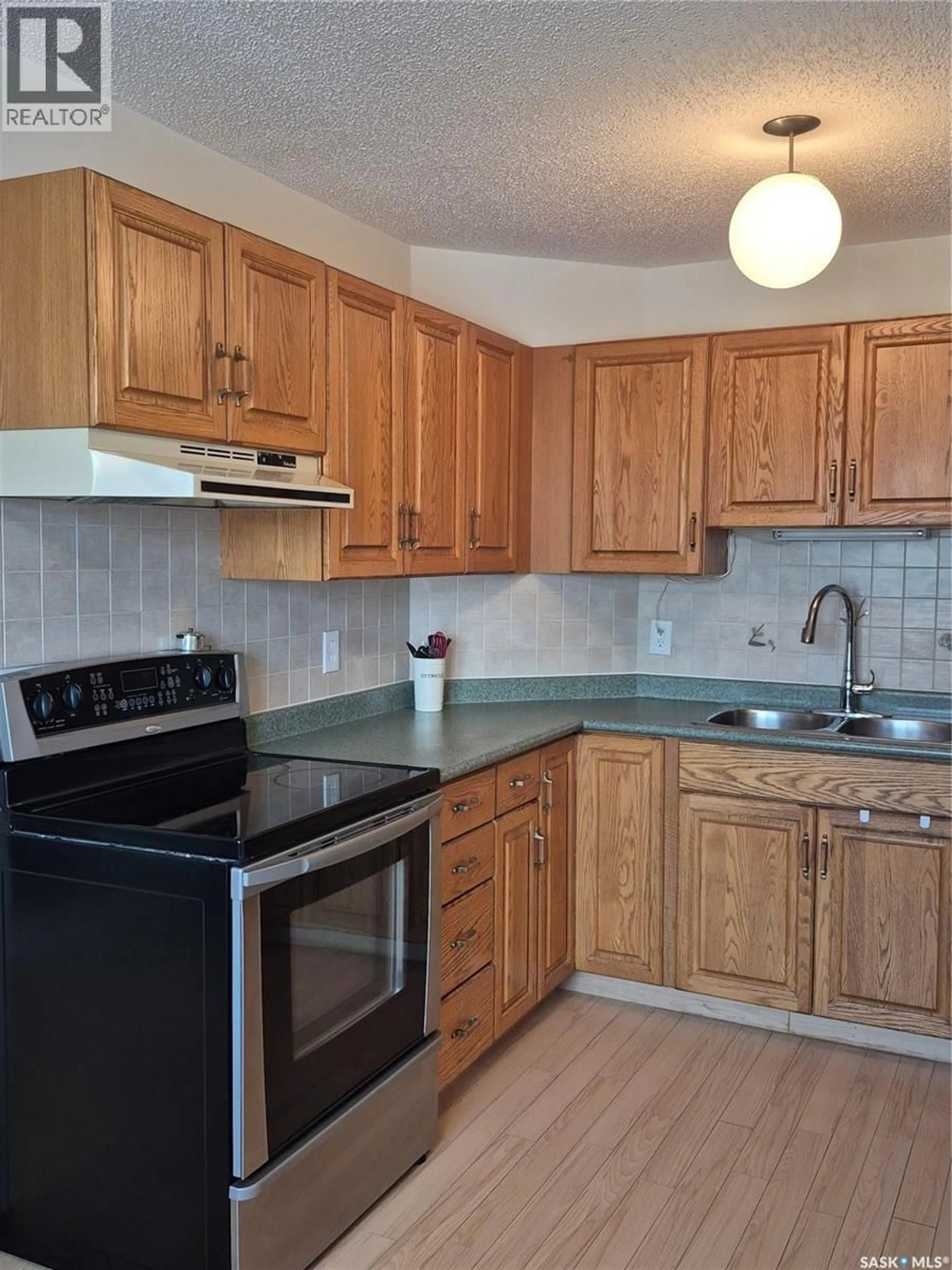 Standard kitchen, wood/laminate floor for 102 - 3220 33RD STREET, Saskatoon Saskatchewan S7L6K3