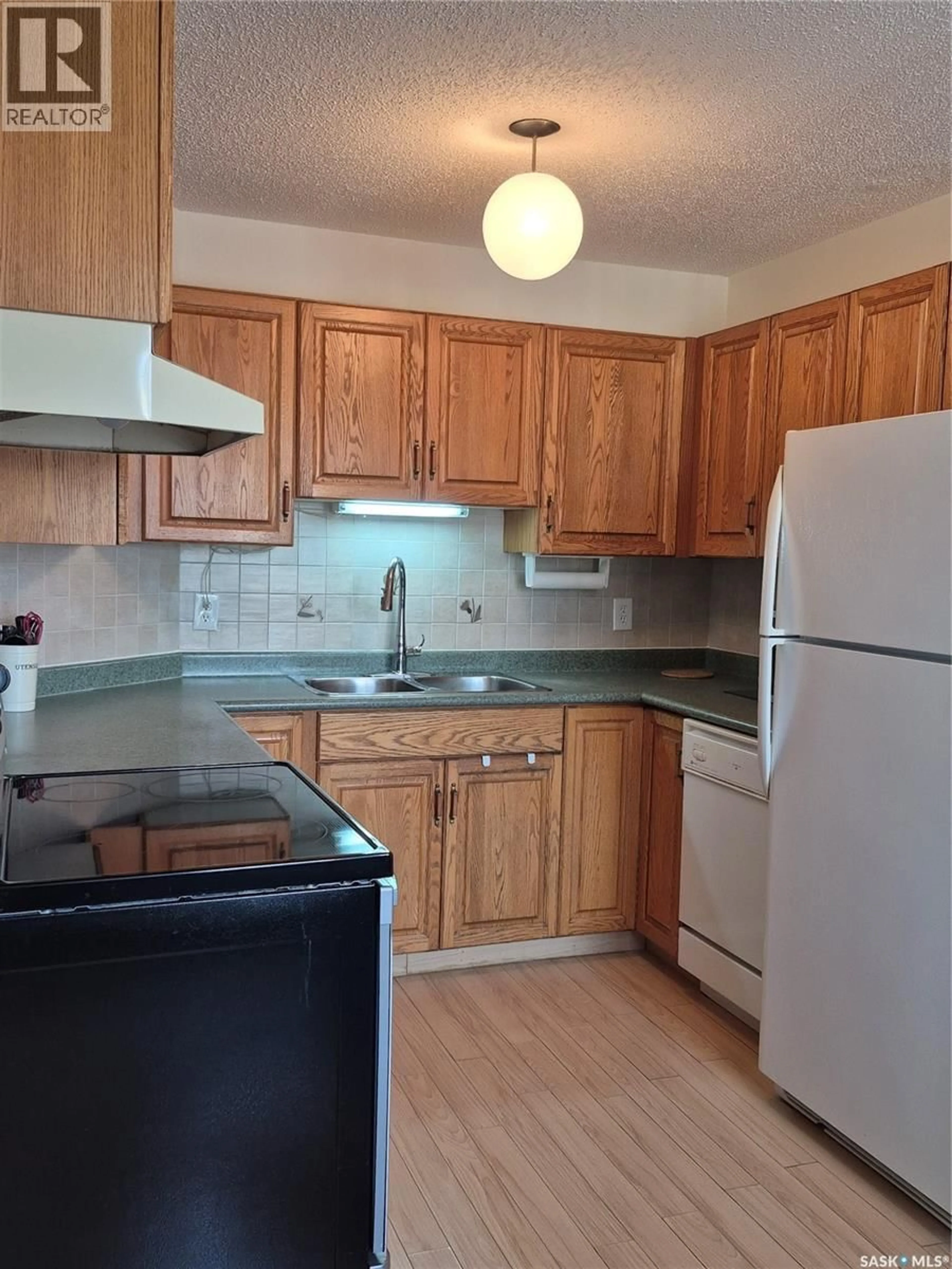 Standard kitchen, wood/laminate floor for 102 - 3220 33RD STREET, Saskatoon Saskatchewan S7L6K3