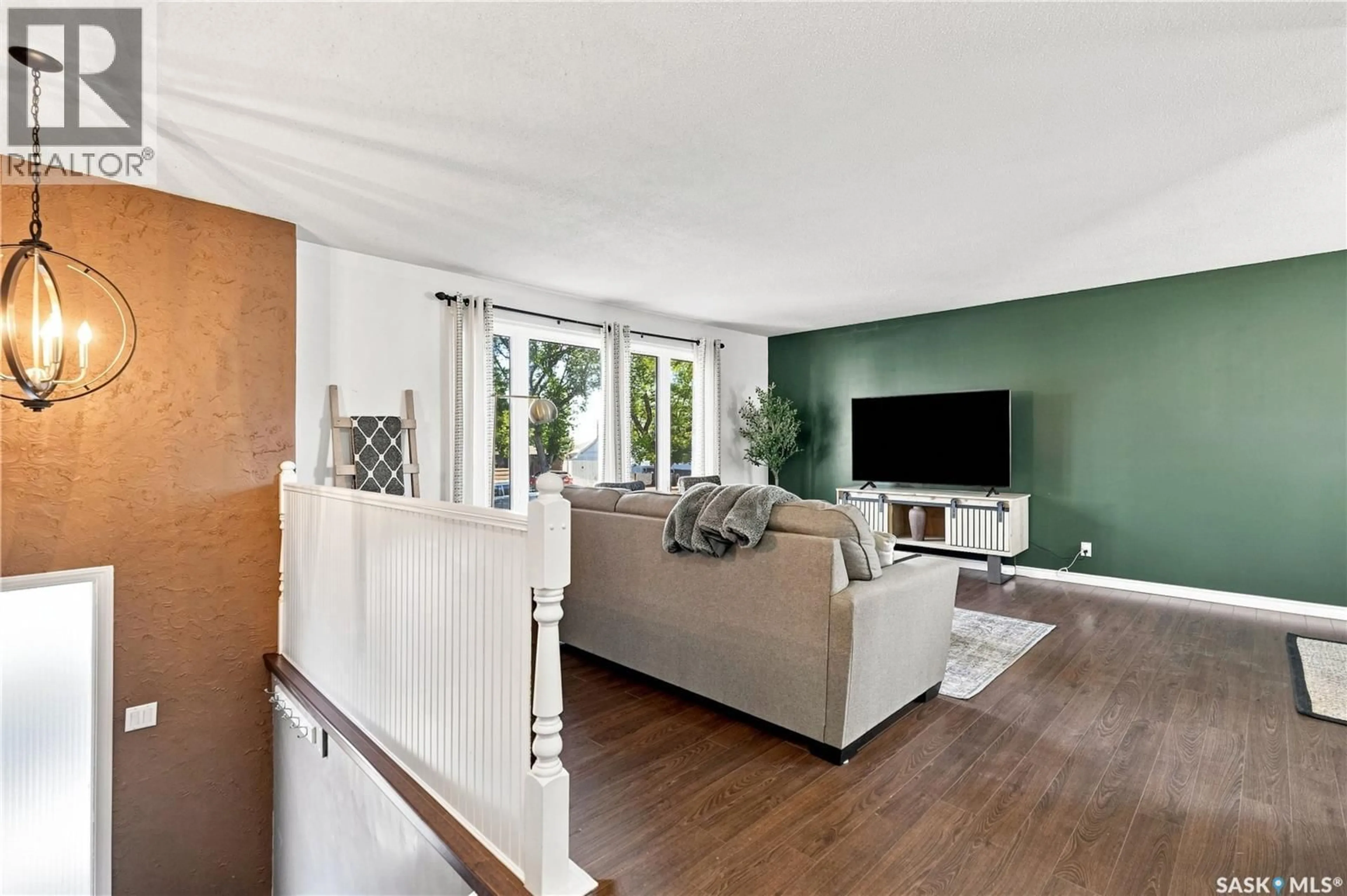 Living room with furniture, wood/laminate floor for 1109 LILLOOET STREET, Moose Jaw Saskatchewan S6H5A2