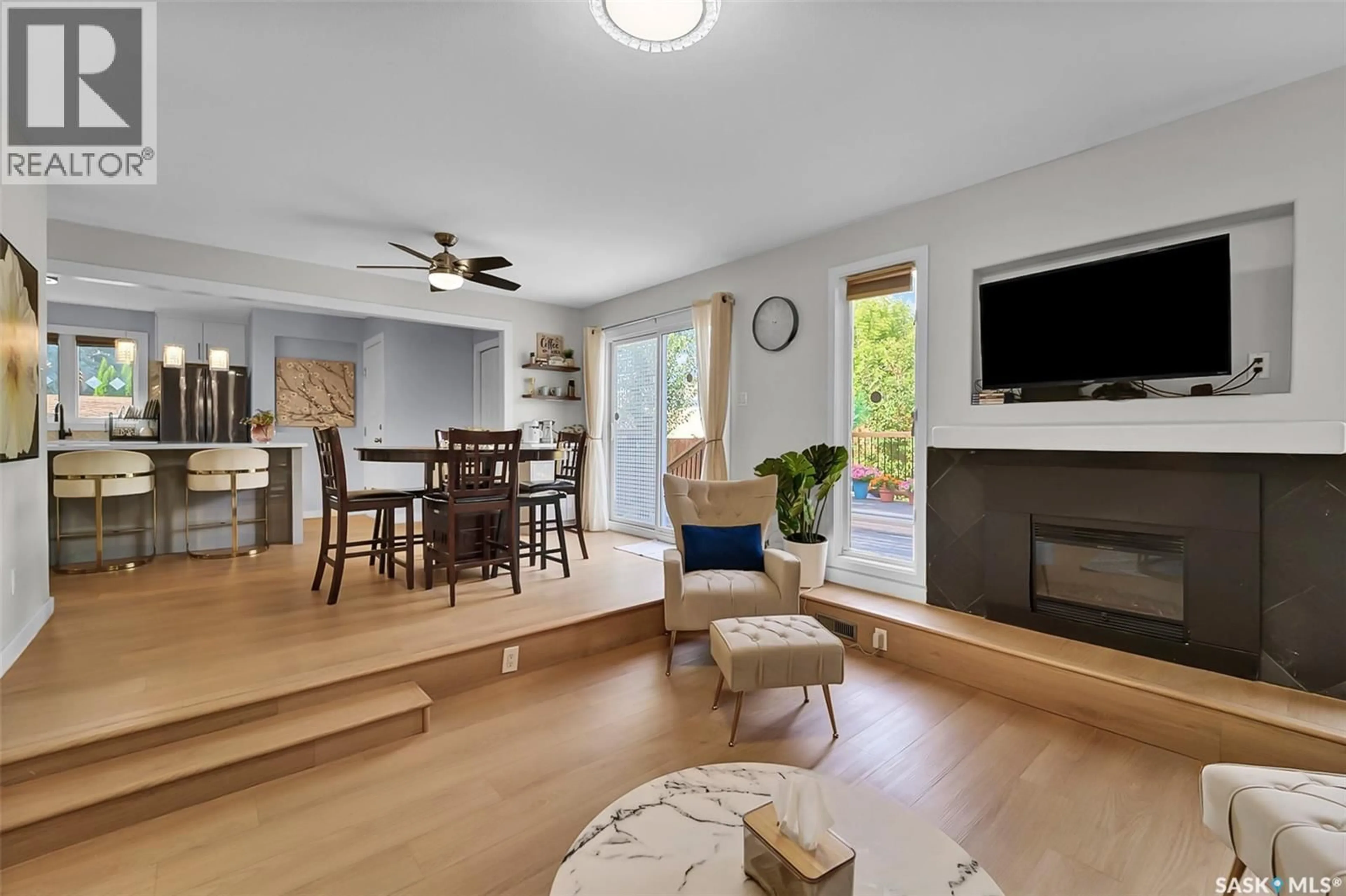 Living room with furniture, wood/laminate floor for 19 BARR PLACE, Saskatoon Saskatchewan S7M4G1