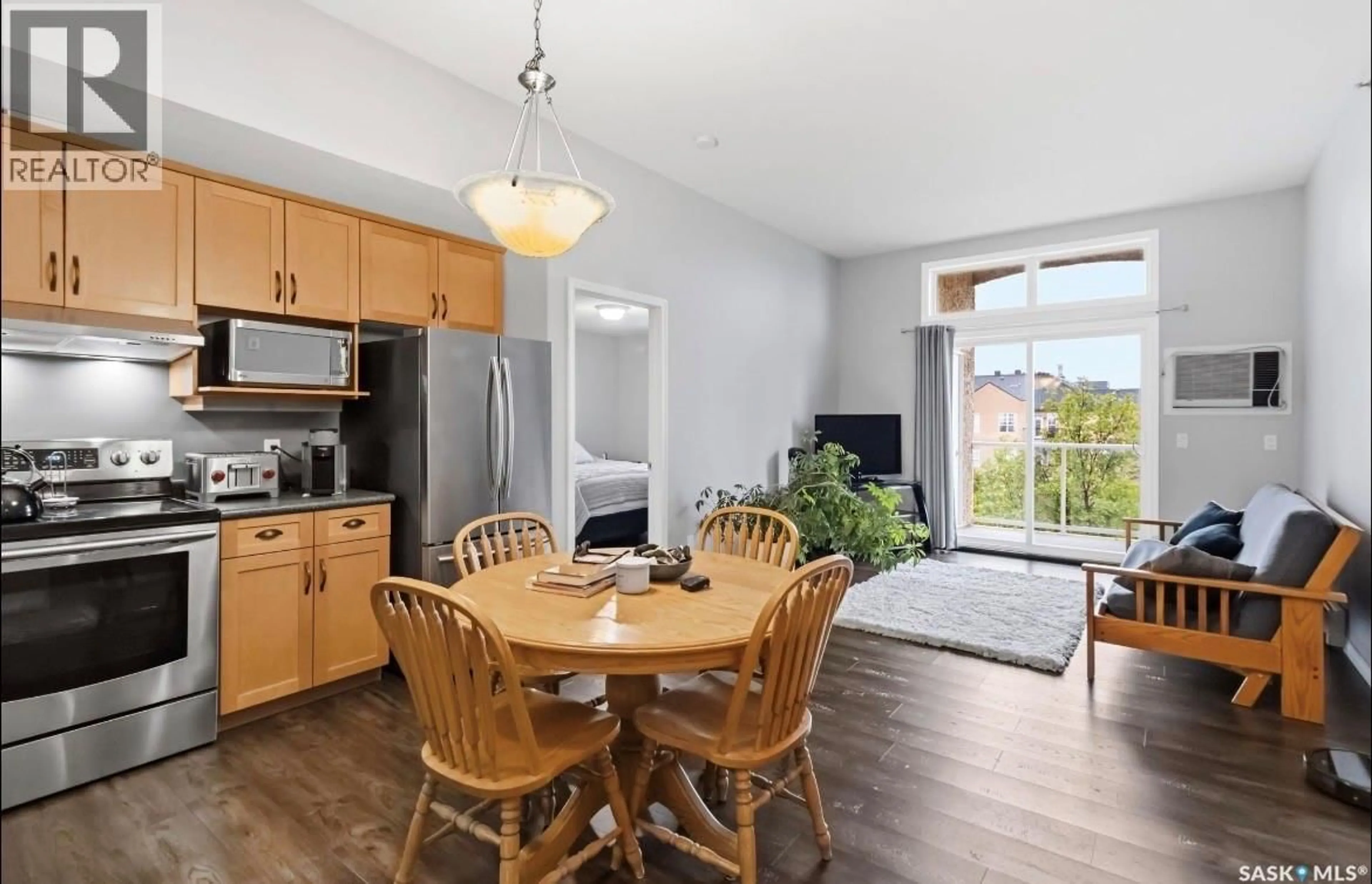 Open concept kitchen, wood/laminate floor for 401 215 LOWE ROAD, Saskatoon Saskatchewan S7S1N1