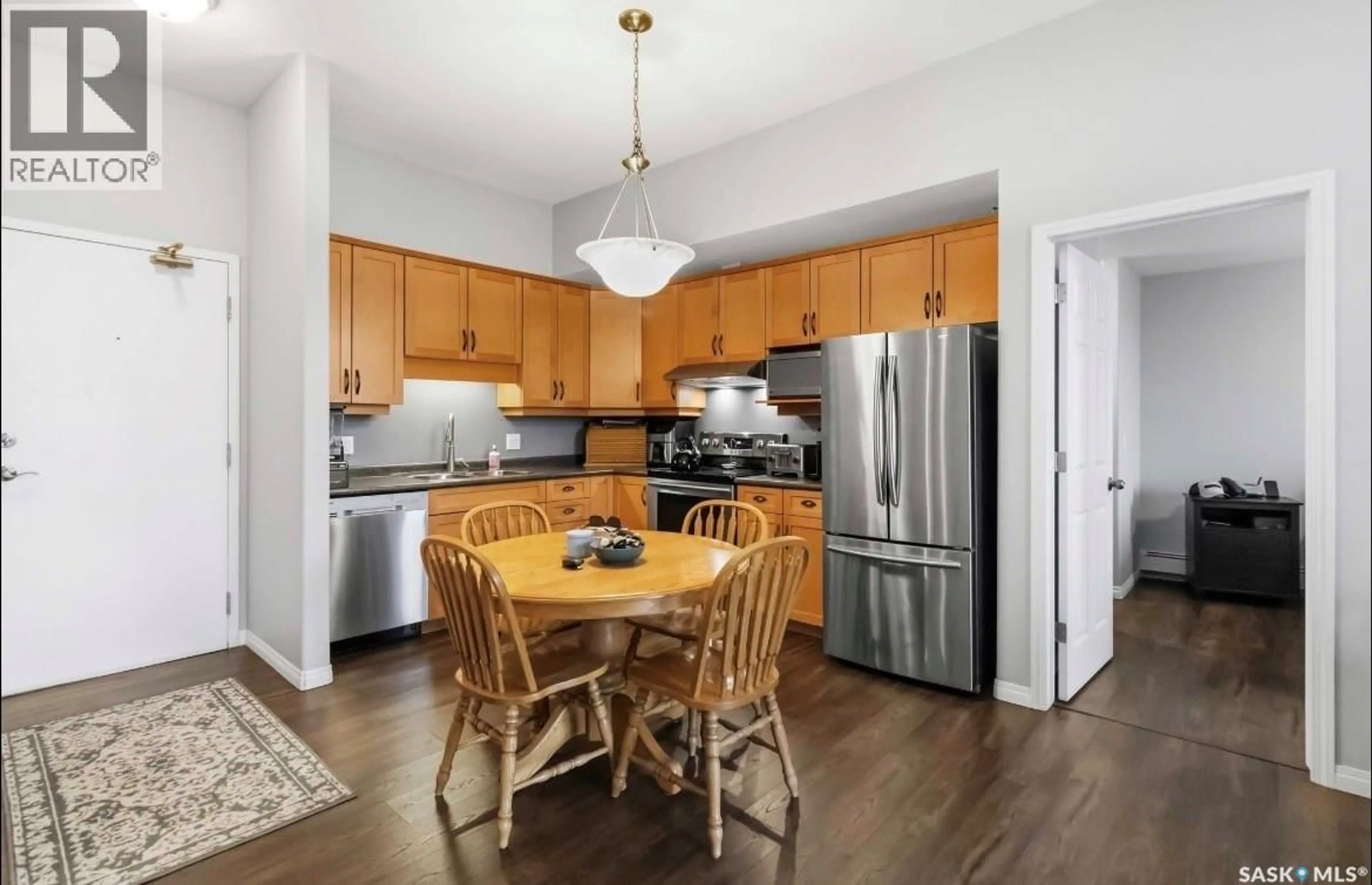 Open concept kitchen, wood/laminate floor for 401 215 LOWE ROAD, Saskatoon Saskatchewan S7S1N1