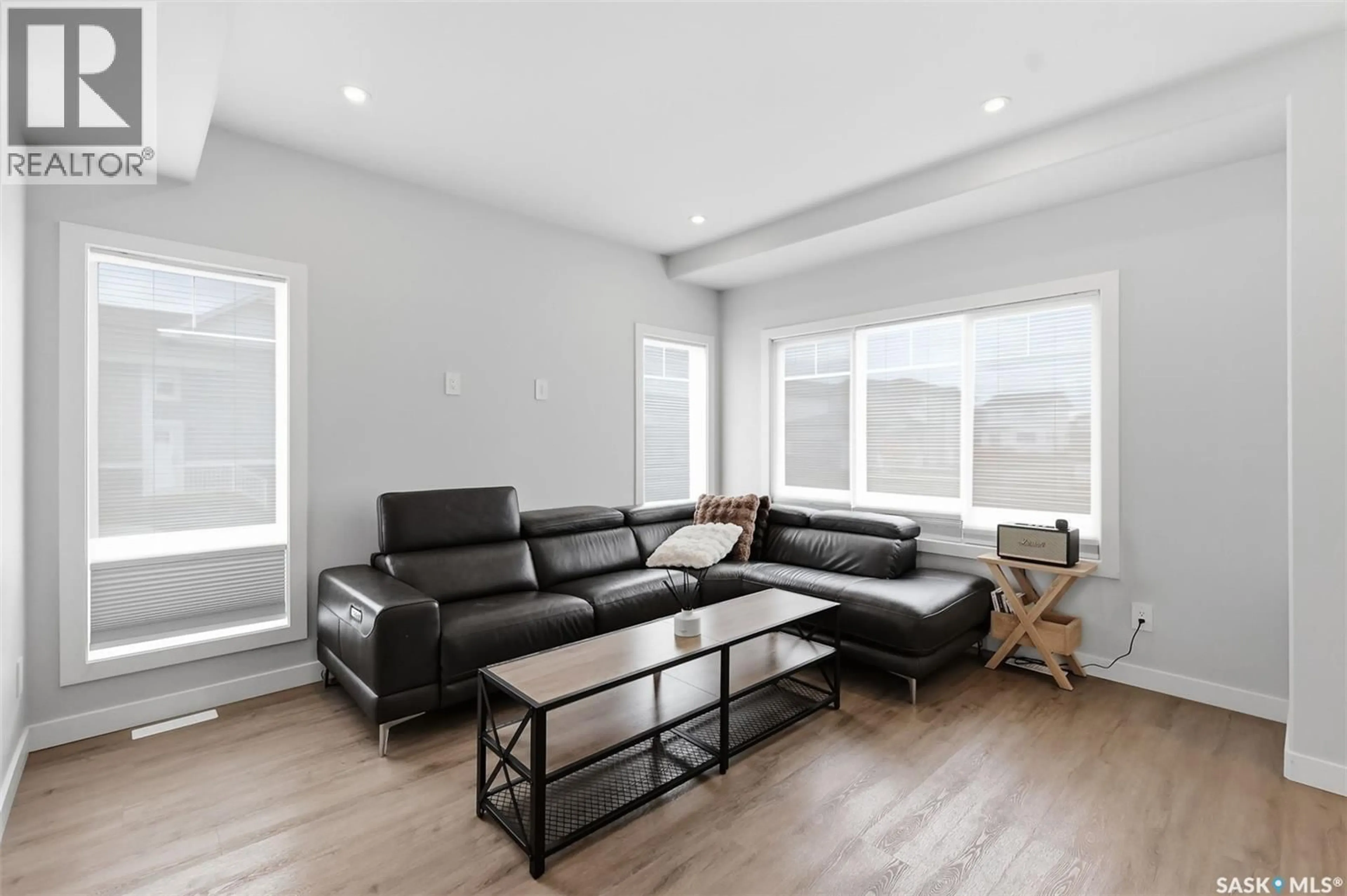 Living room with furniture, wood/laminate floor for 122 TASKAMANWA STREET, Saskatoon Saskatchewan S7V1P6