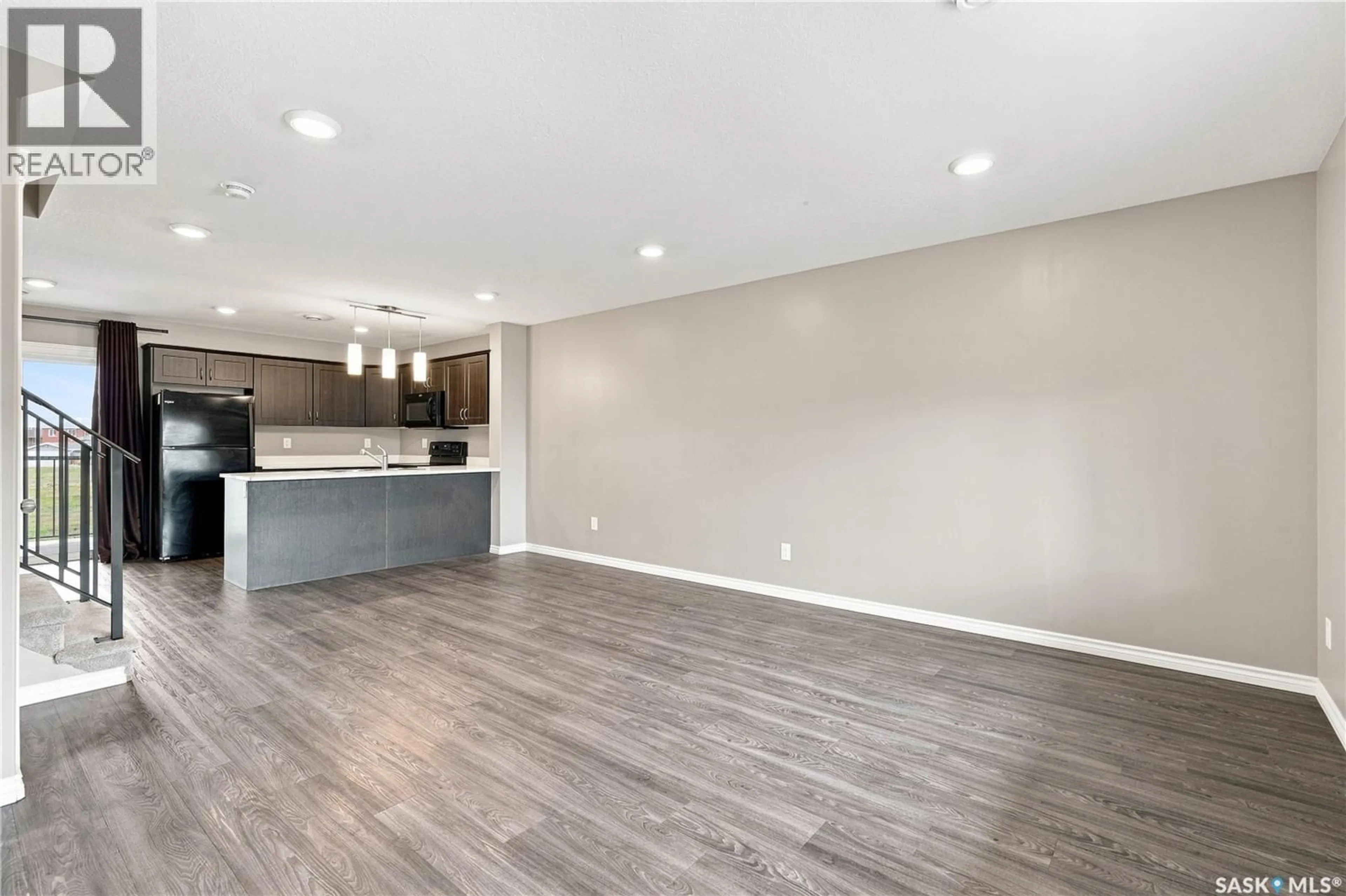 Open concept kitchen, wood/laminate floor for 110 - 617 AKHTAR BEND, Saskatoon Saskatchewan S7W0Y9