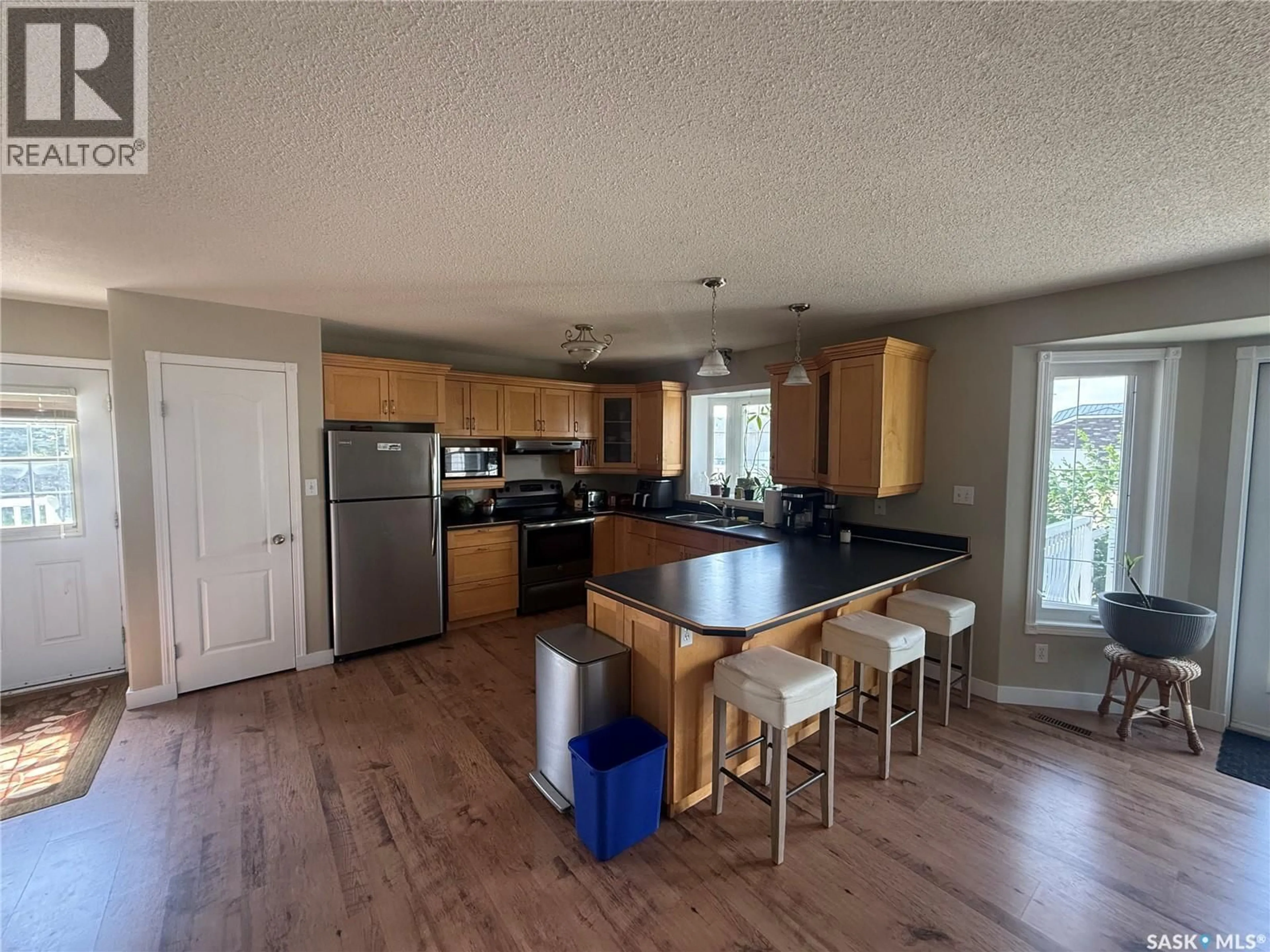 Open concept kitchen, wood/laminate floor for 6 SHAW PLACE, Assiniboia Saskatchewan S0H0B0