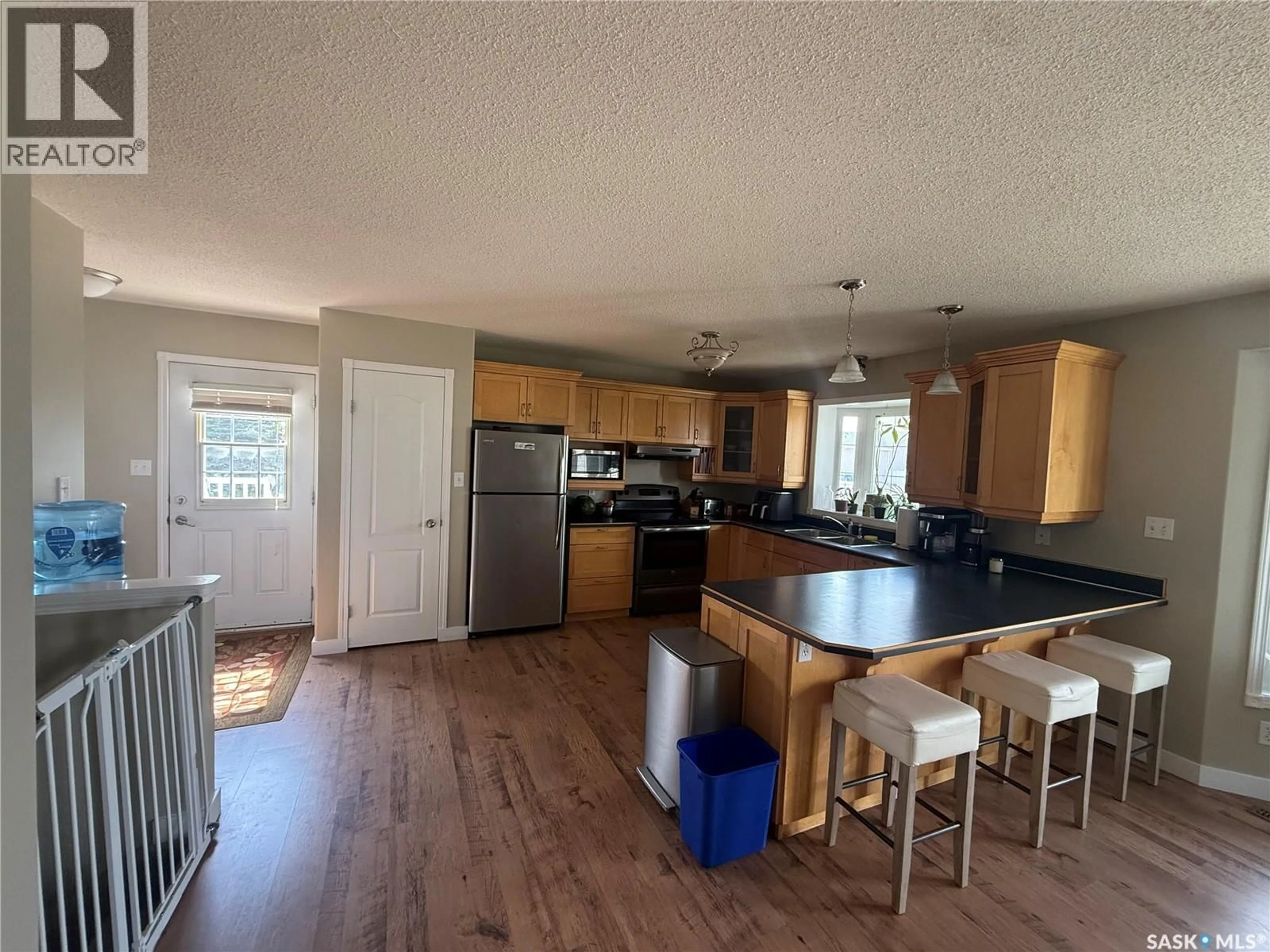 Open concept kitchen, wood/laminate floor for 6 SHAW PLACE, Assiniboia Saskatchewan S0H0B0