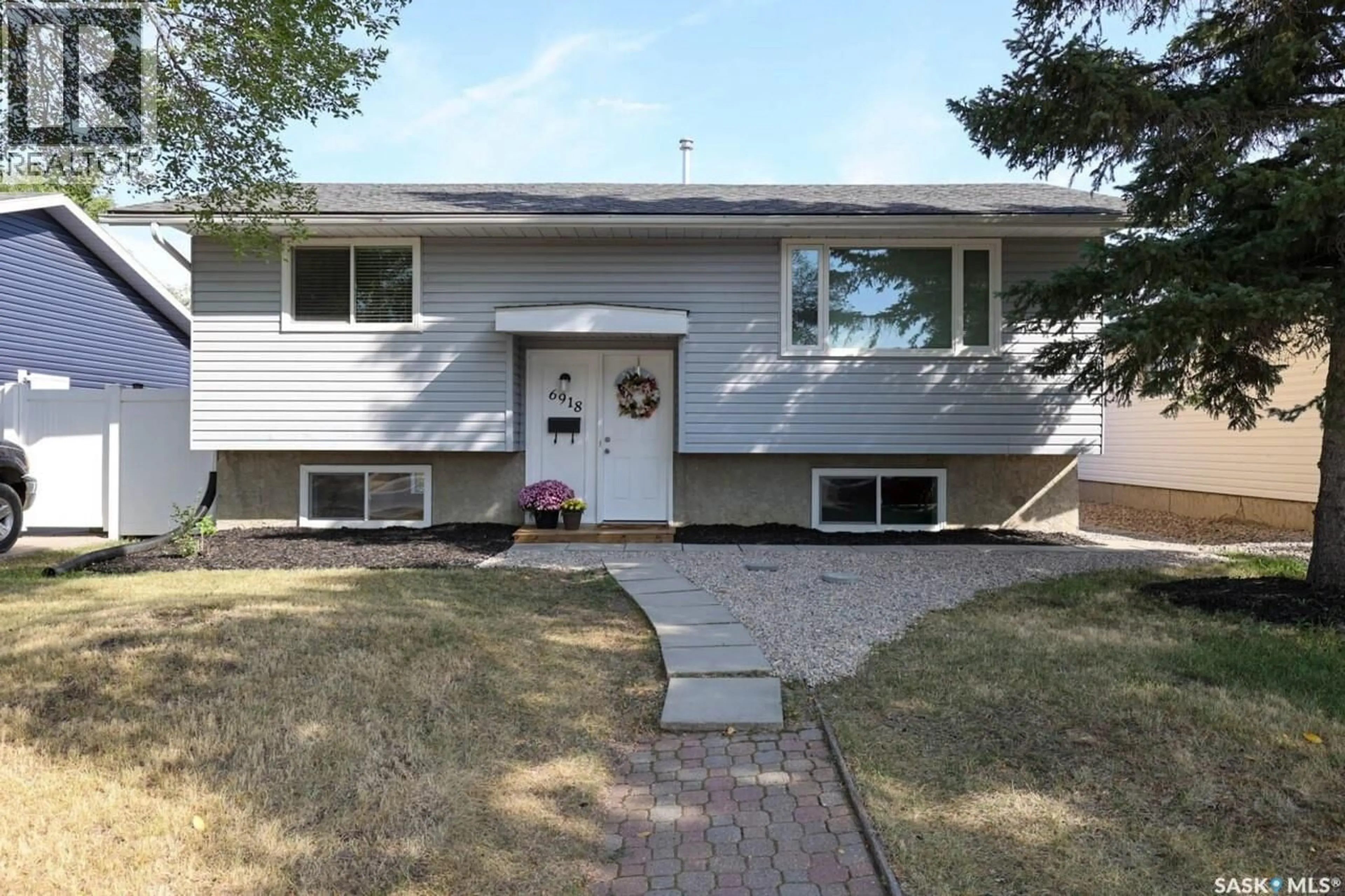Home with vinyl exterior material, street for 6918 1ST AVENUE, Regina Saskatchewan S4X1J2