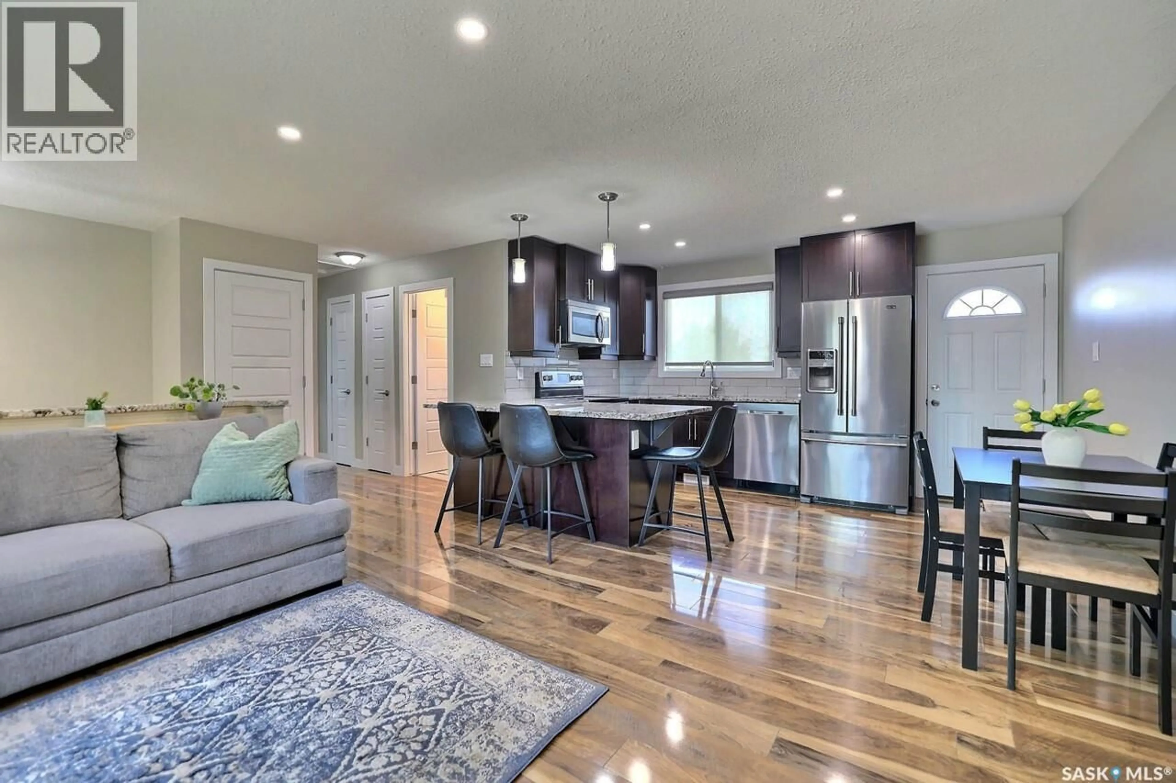 Open concept kitchen, wood/laminate floor for 6918 1ST AVENUE, Regina Saskatchewan S4X1J2