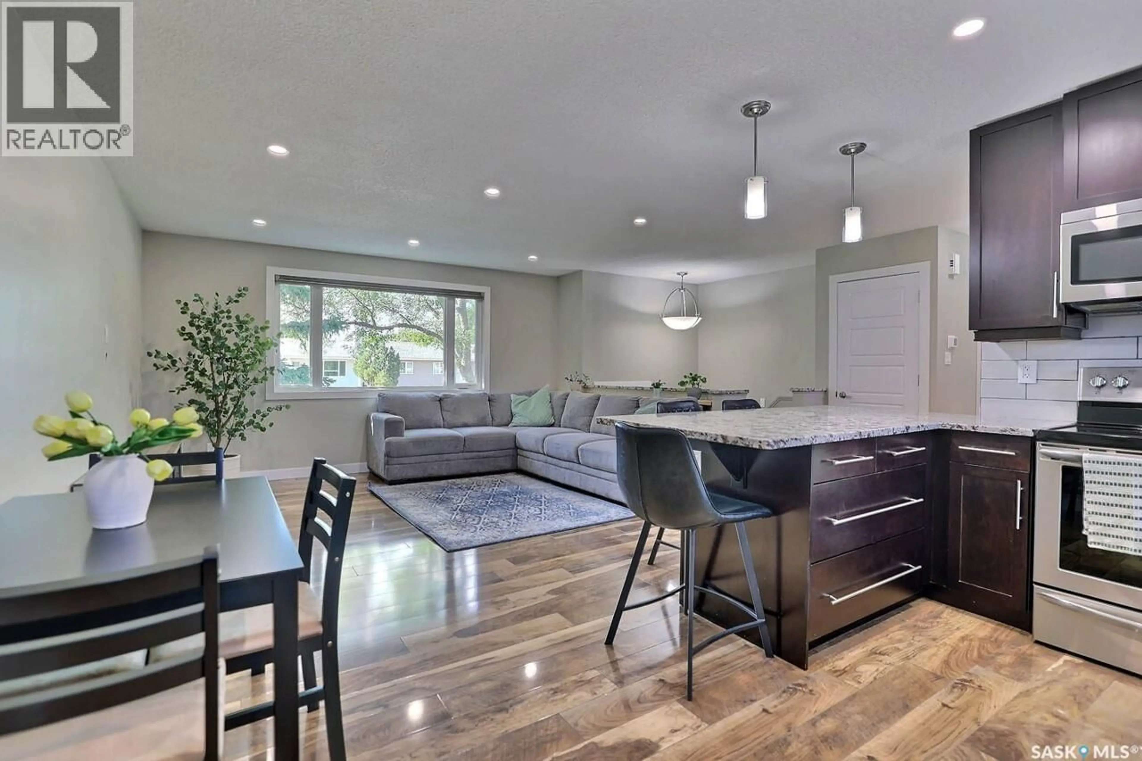 Open concept kitchen, wood/laminate floor for 6918 1ST AVENUE, Regina Saskatchewan S4X1J2