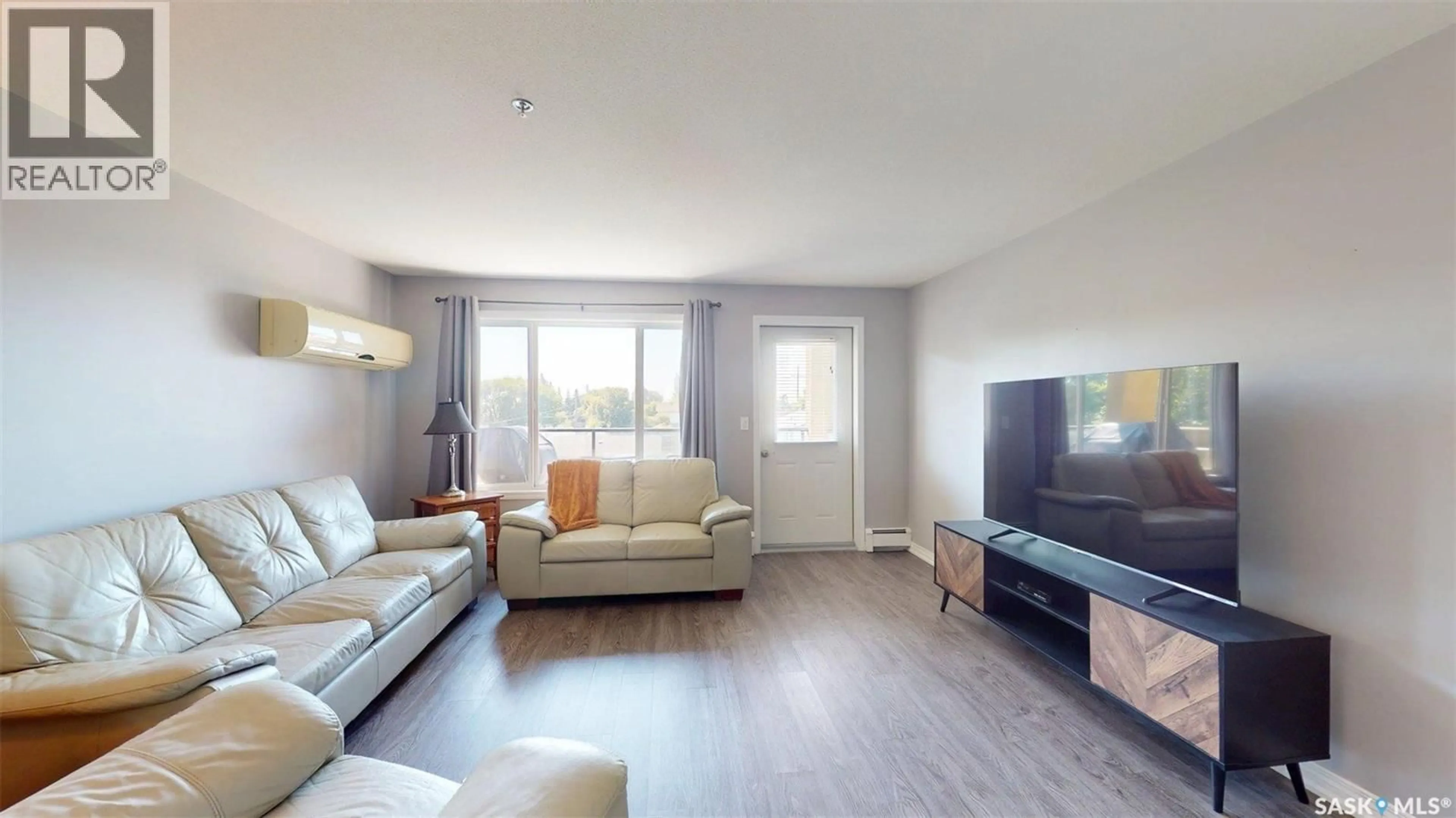 Living room with furniture, wood/laminate floor for 600 - 210 CENTENNIAL BOULEVARD, Warman Saskatchewan S0K4S1