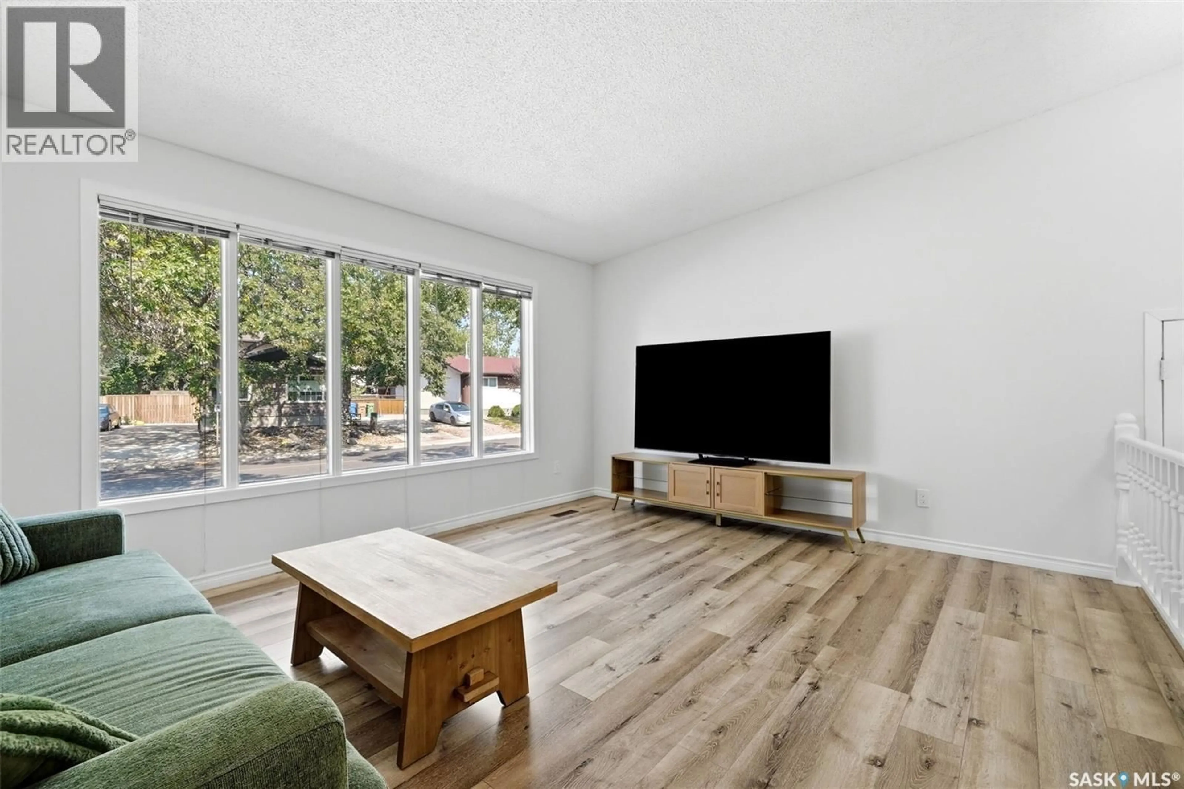 Living room with furniture, wood/laminate floor for 6119 DALGLIESH DRIVE, Regina Saskatchewan S4X2K3