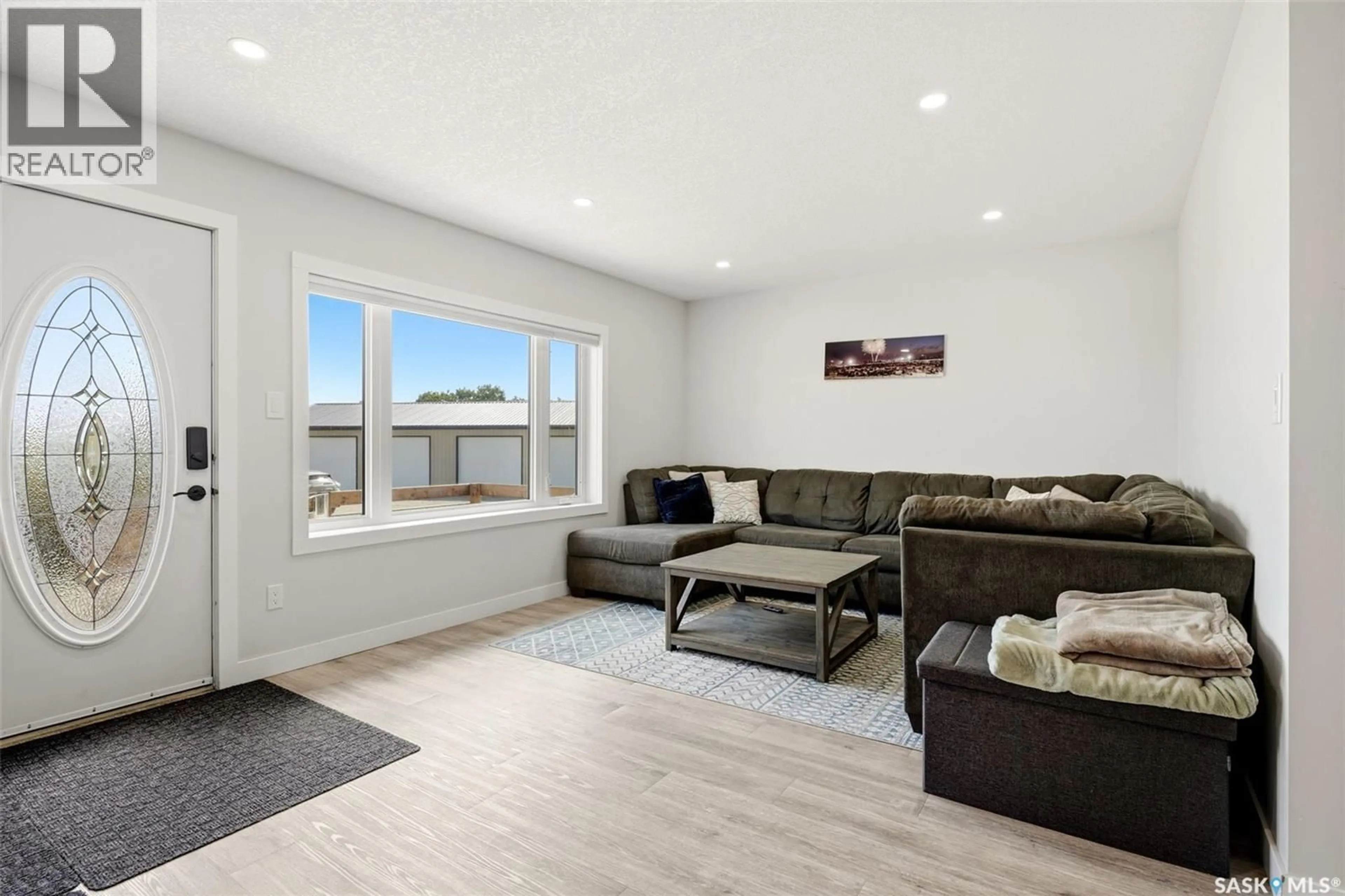 Living room with furniture, wood/laminate floor for HARDEN ACREAGE, South Qu'Appelle Rm No. 157 Saskatchewan S0G1K0